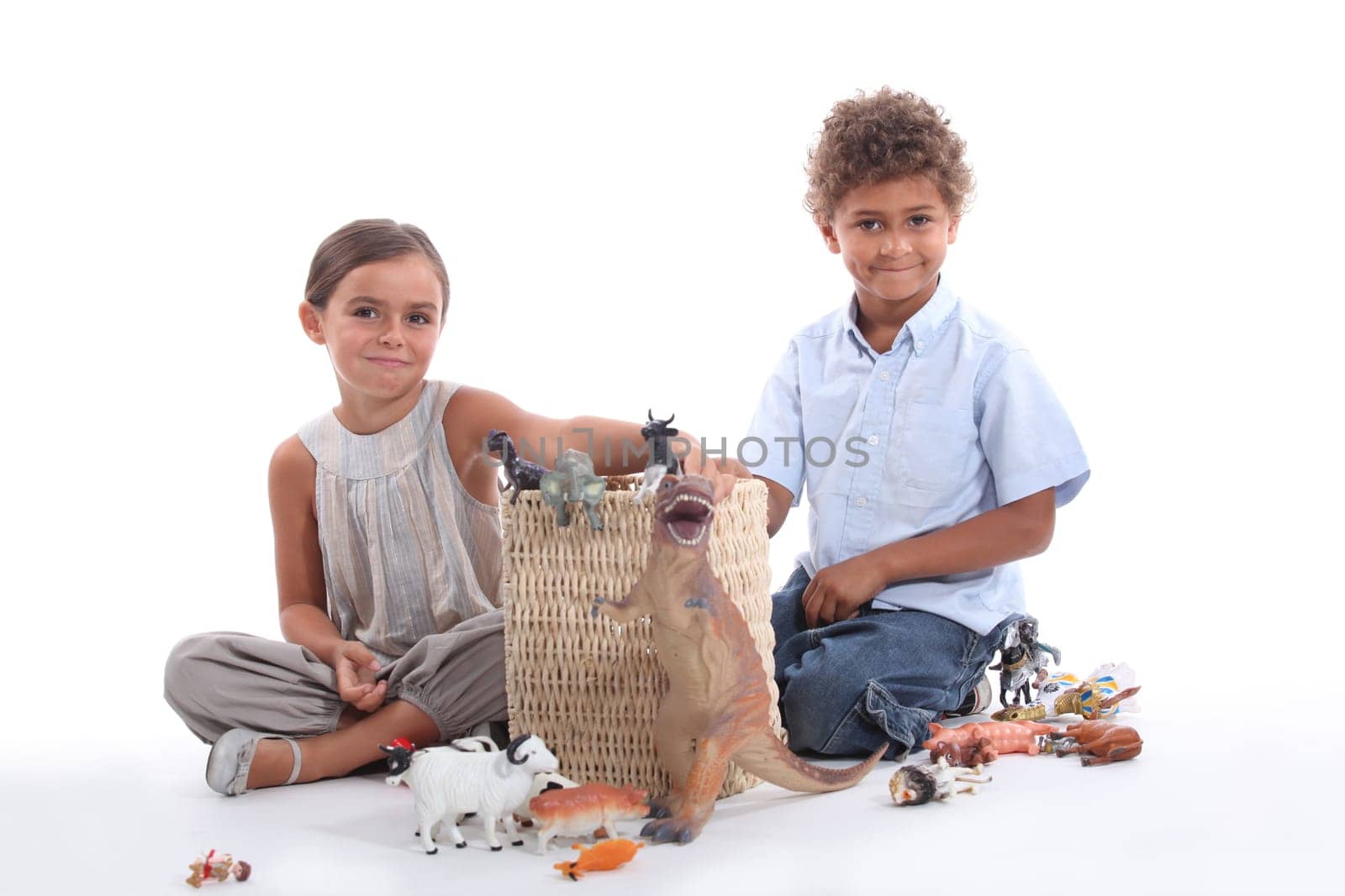 Brother and sister playing with toy animals