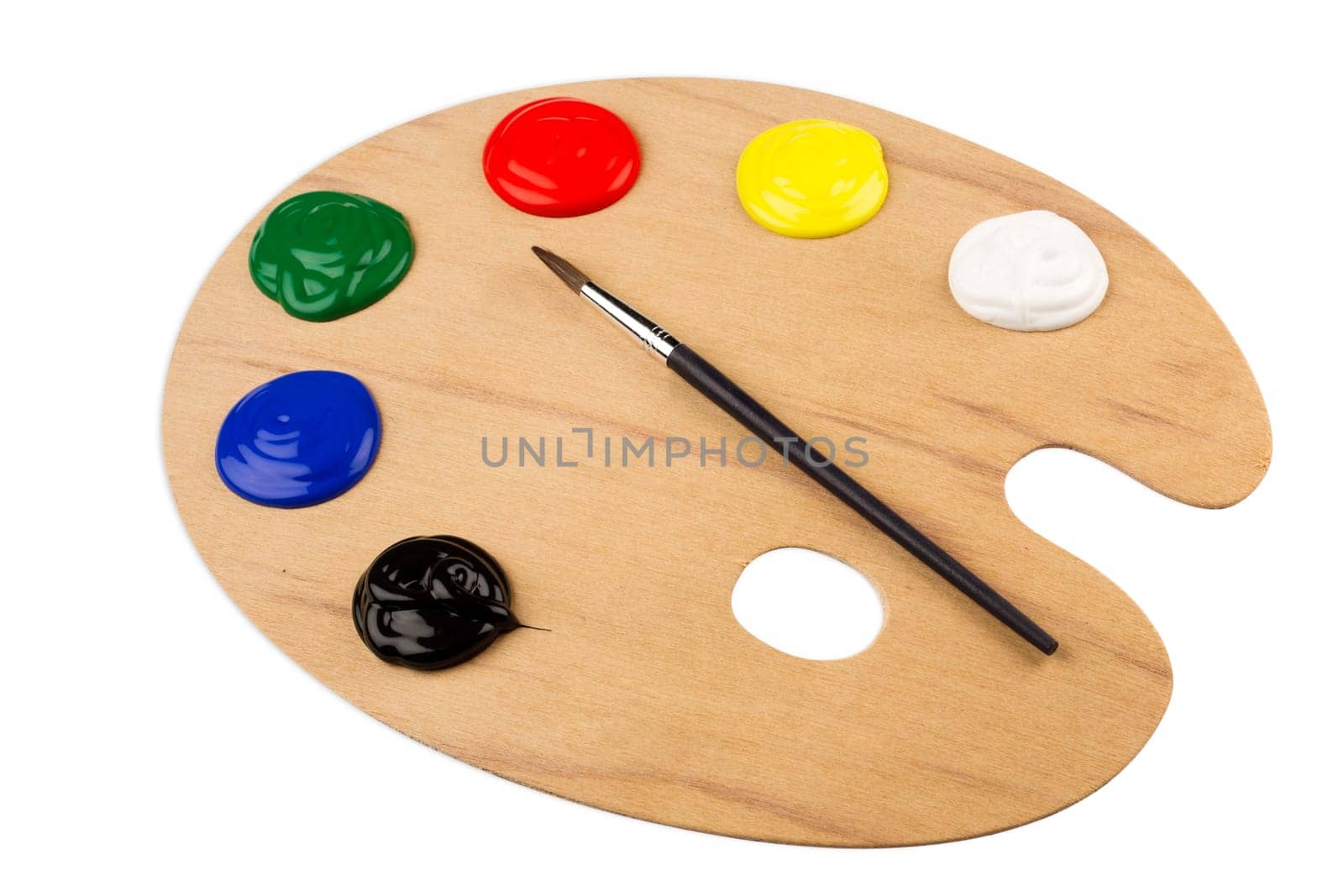 Wooden color palette with paint and brush.