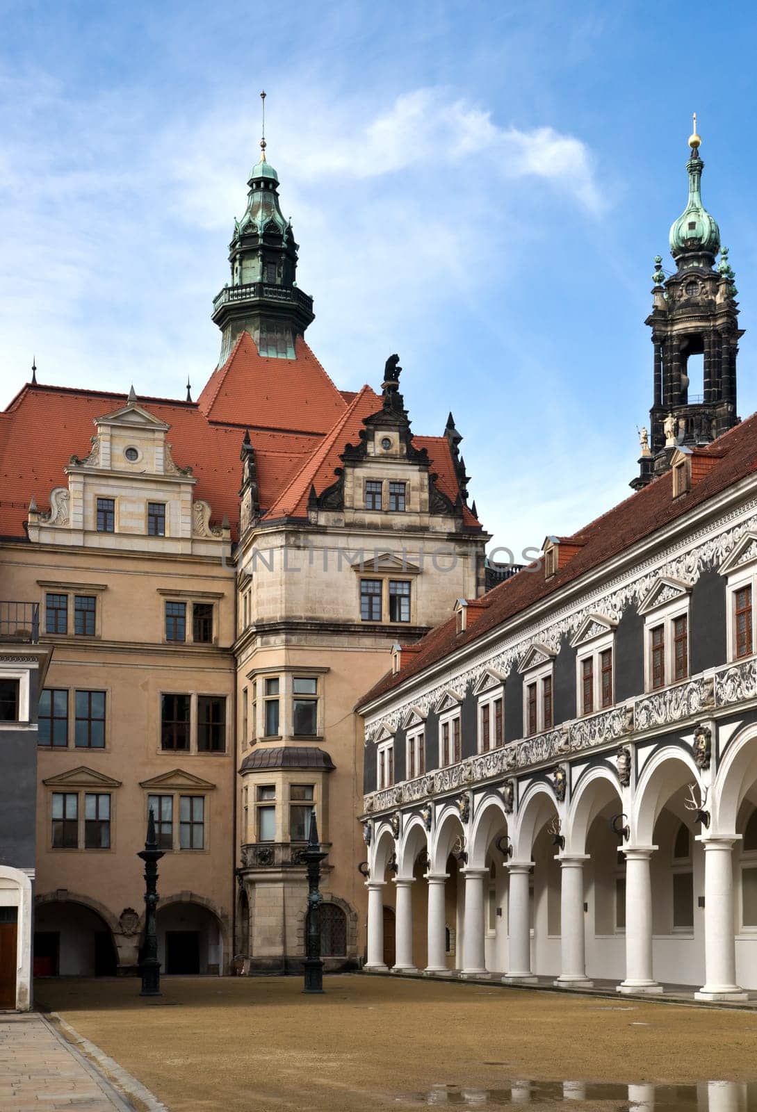 The historic Stall Courtyard and parts of the exquisite Royal Palace in Dresden against a nice blue sky with some white cloud.