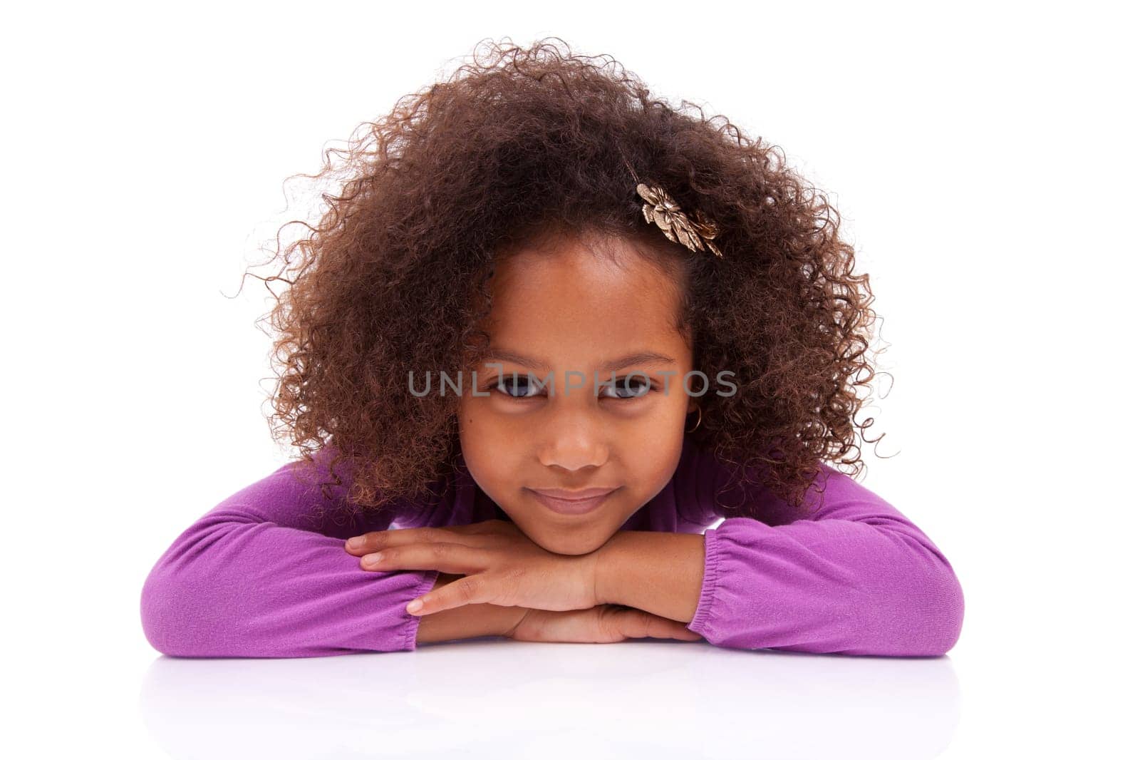 Portrait of a cute little African Asian girl lying down on the floor