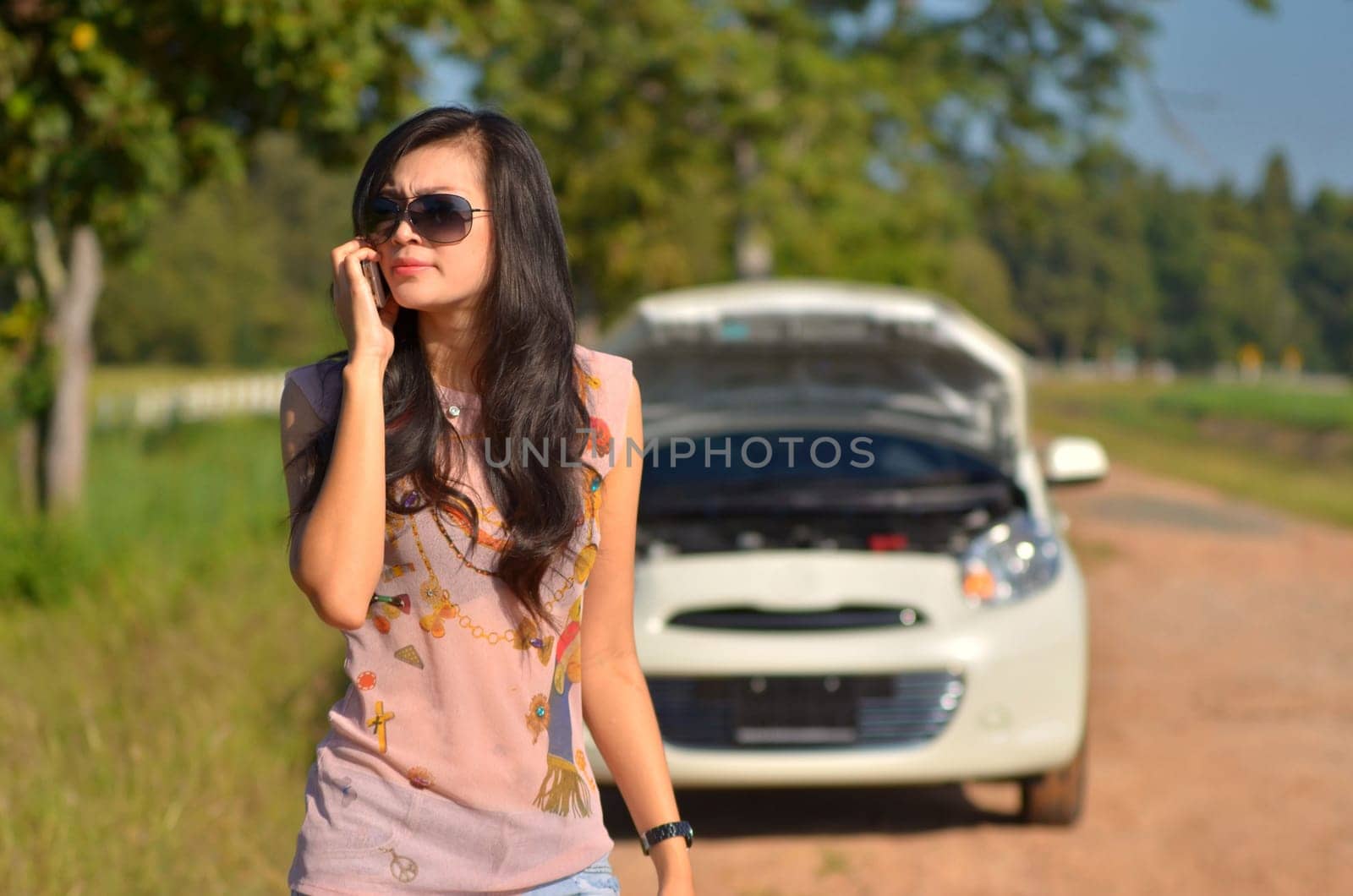 A woman calls for assistance  after her car broke down