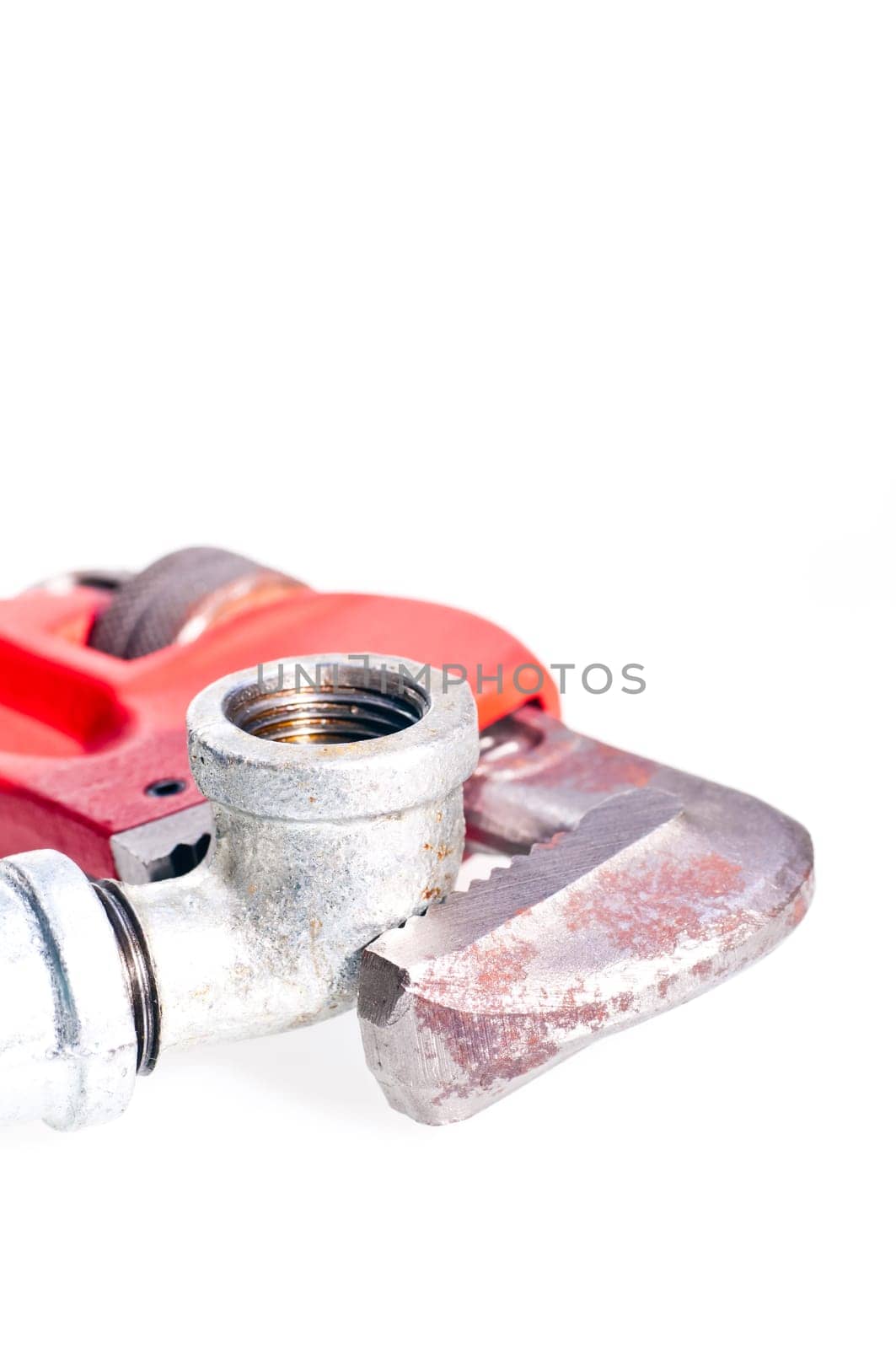Pipe wrench fixing a tap joint - concept : plumbing
