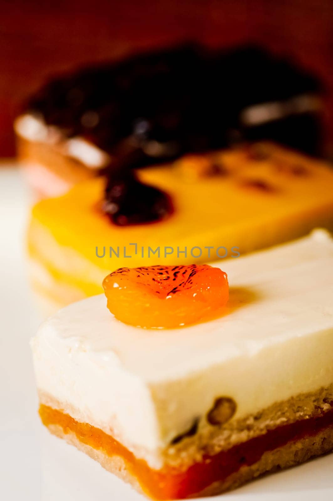 Three assorted cakes slices on a white plate