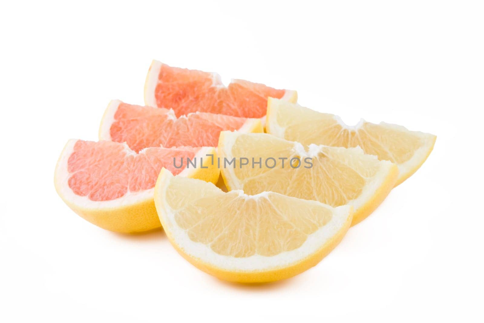Juicy white and red grapefruits parts isolated on white