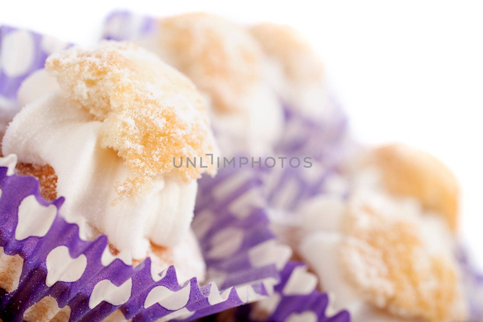 Freshly baked cup cakes with cream filling in cake trays
