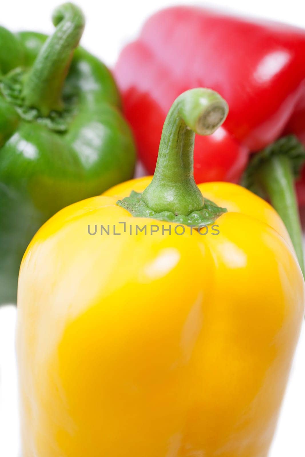 Red Yellow and Green peppers laid out next to each other