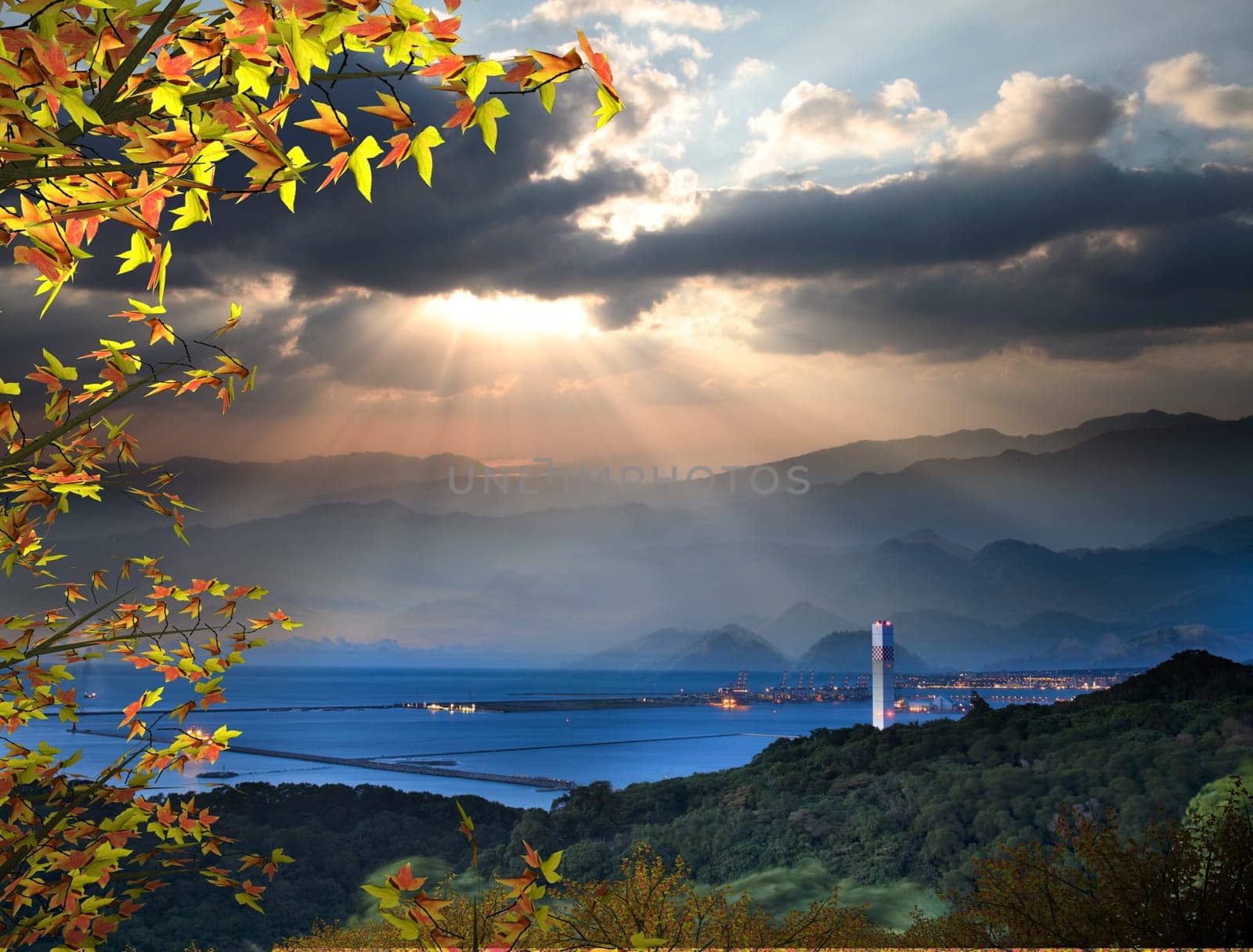 The sun setting over mountains with nice maple