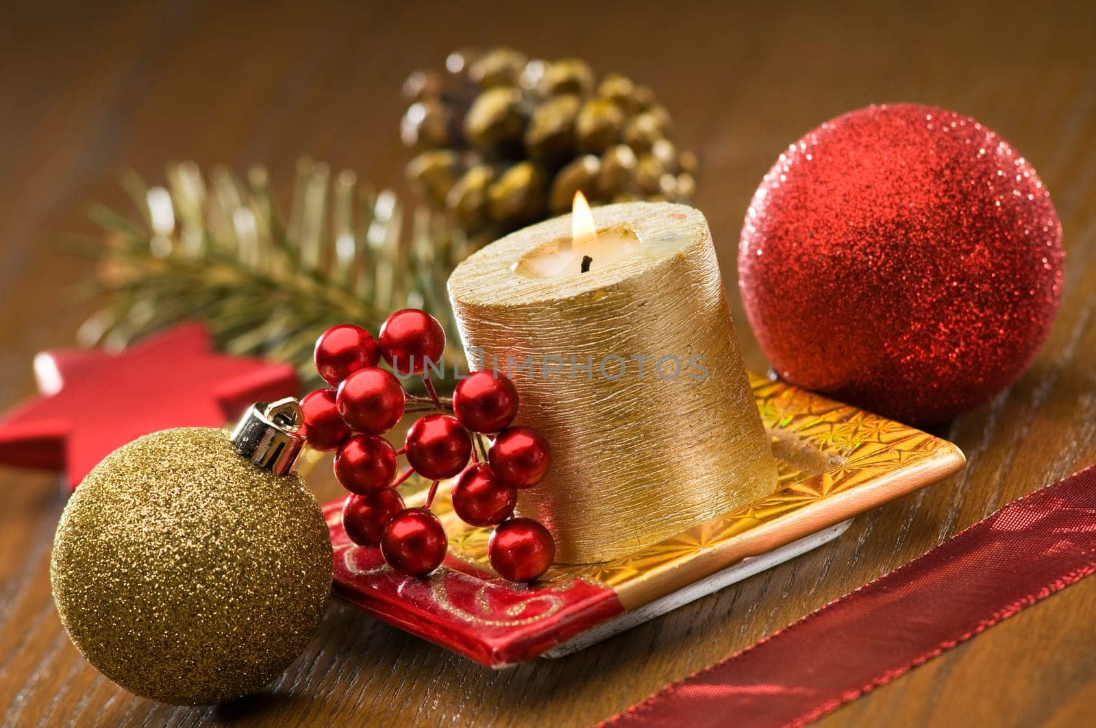 golden candle with christmas ornaments close up shoot