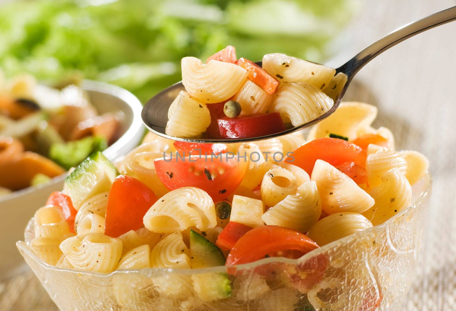 fresh pasta salad with spoon close up shoot