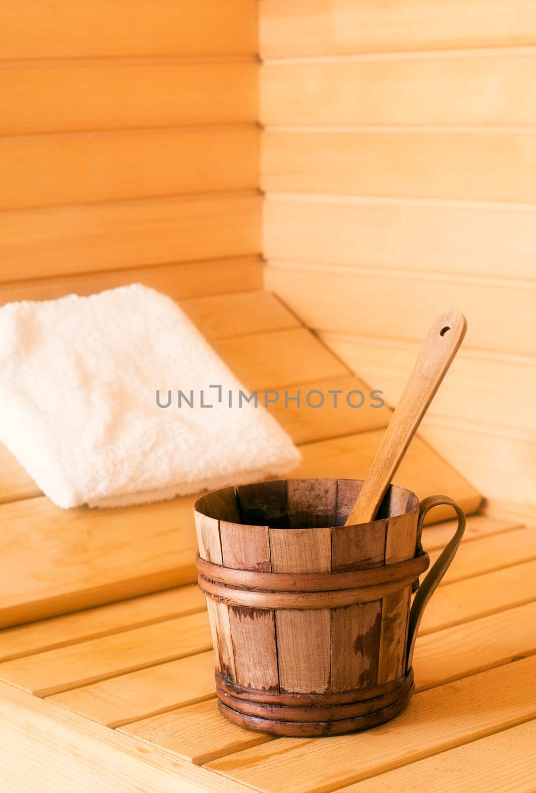 wooden bowl with spoon in sauna close up