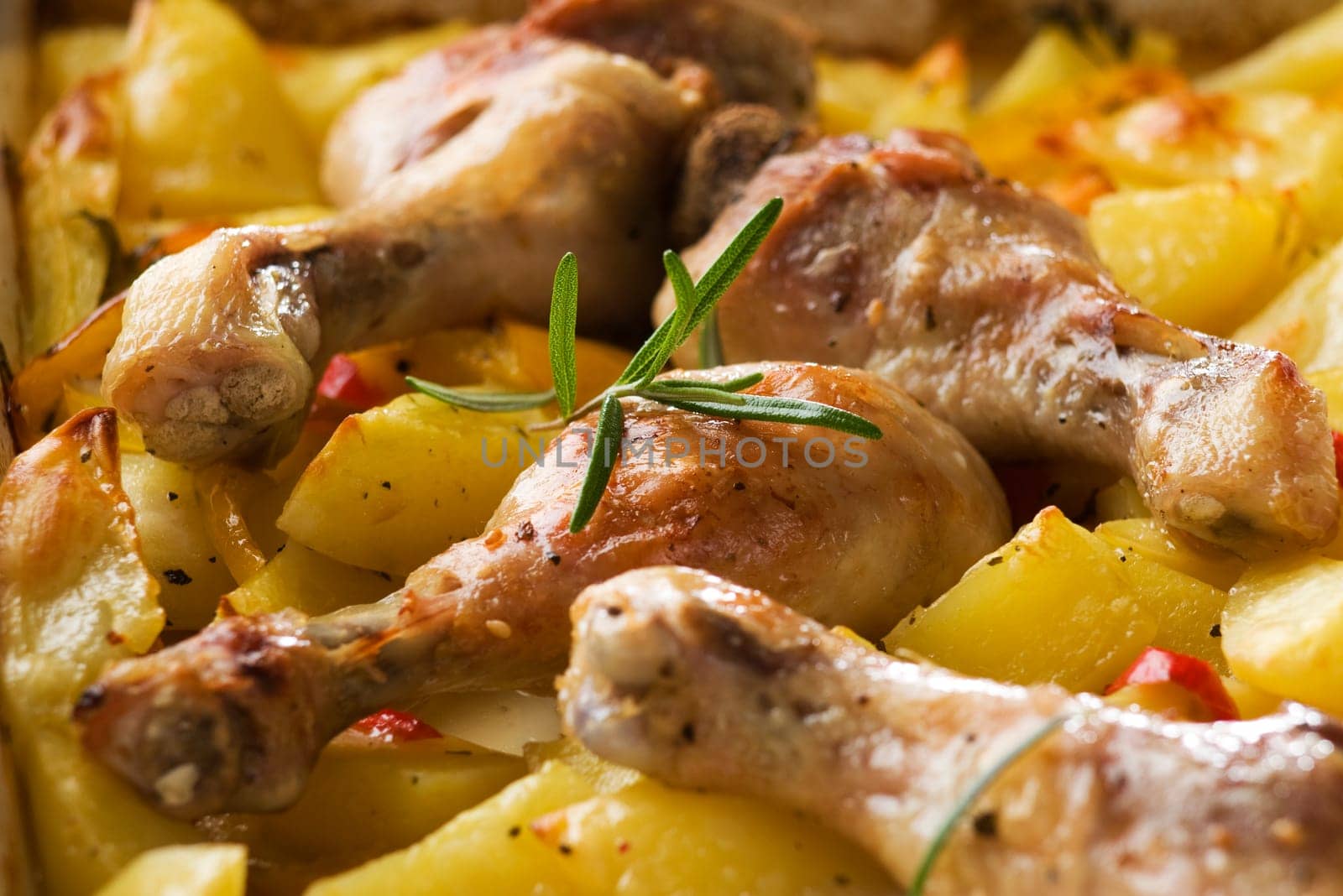 Roasted chicken with potatoes and rosemary close up