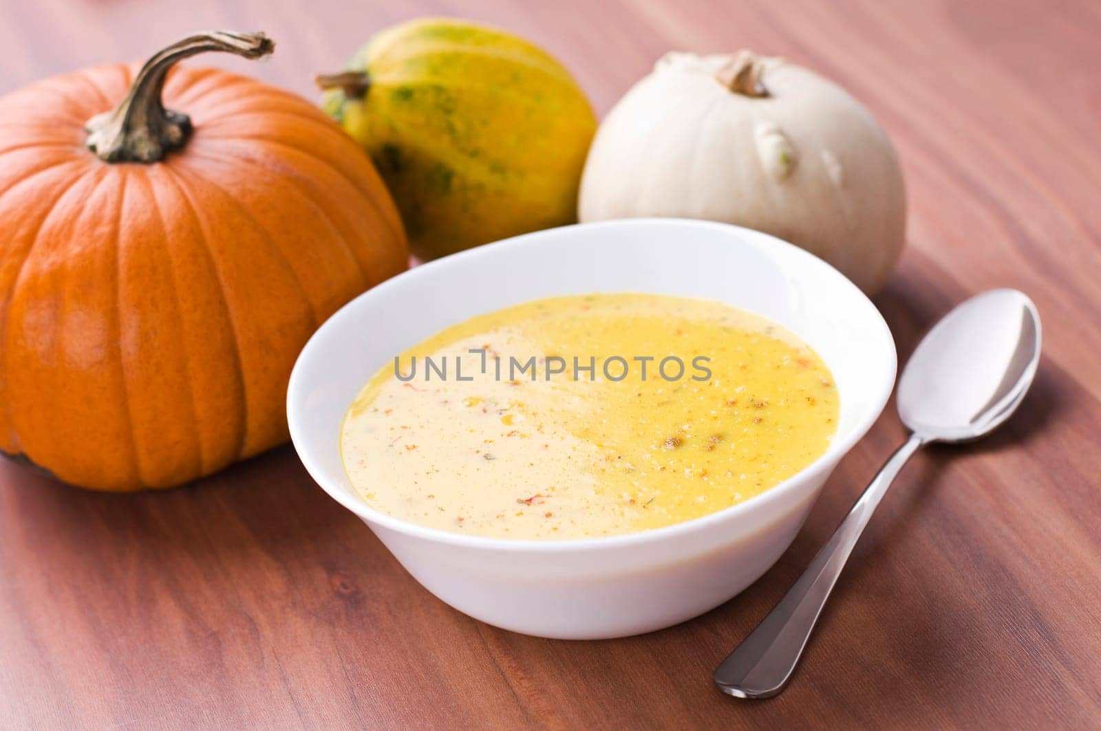 Fresh pumpkin soup with parsley close up