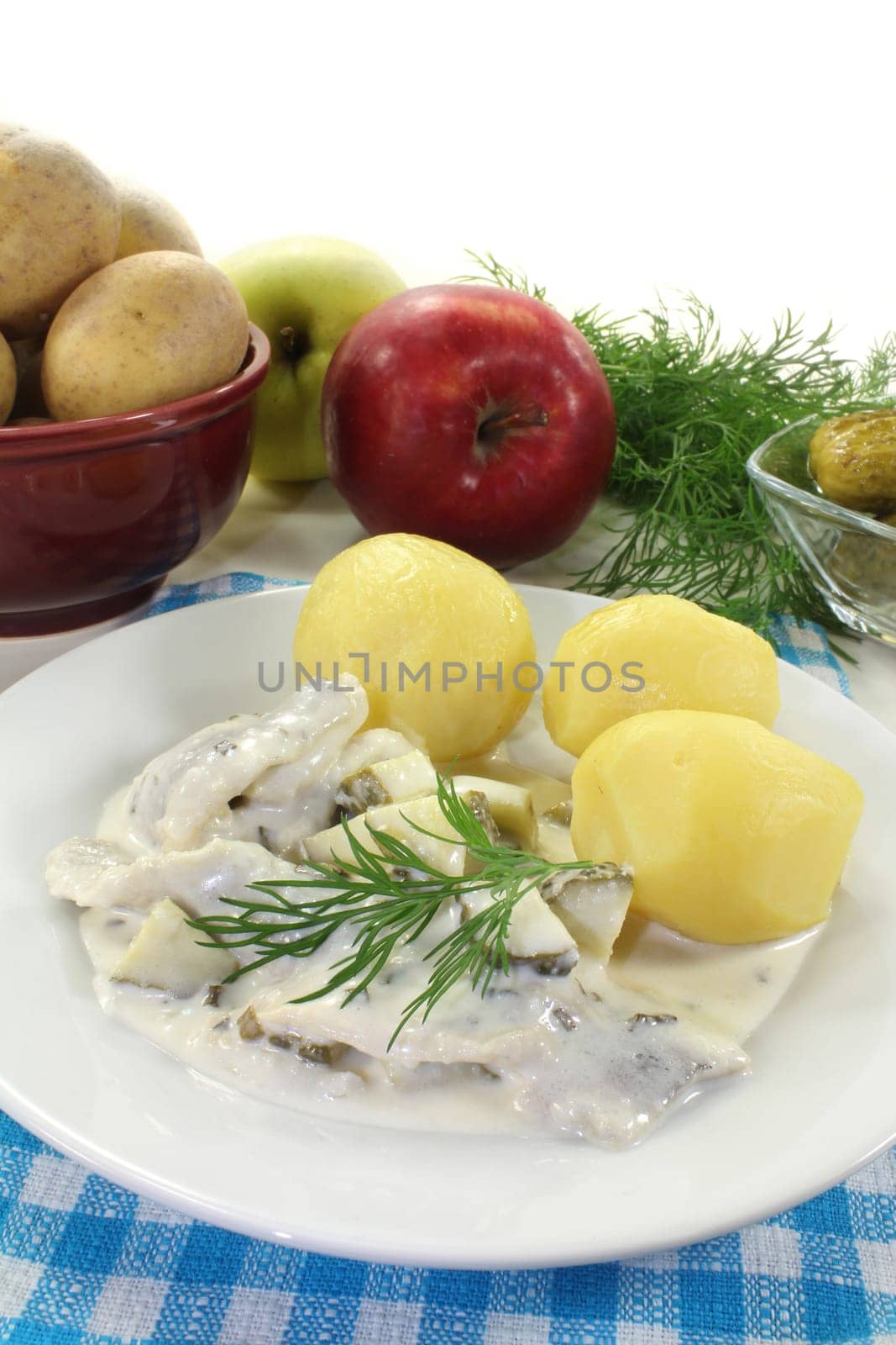 Cream herring with cucumber and jacket potatoes