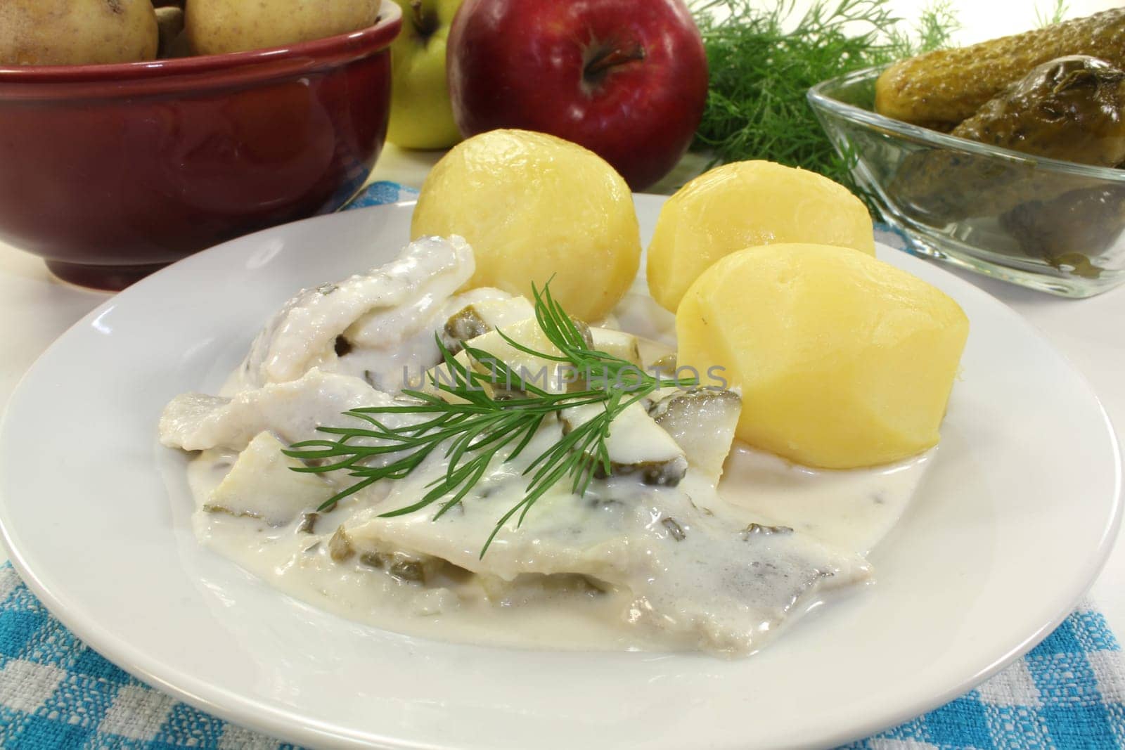 Cream herring with cucumber and jacket potatoes