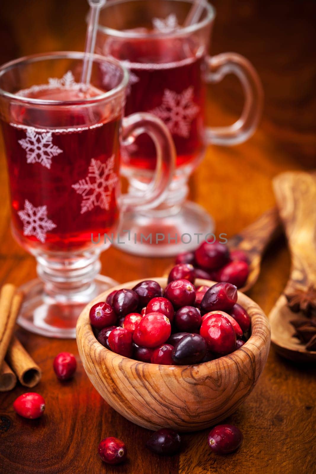 Cranberries in wooden bowl with hot mulled wine