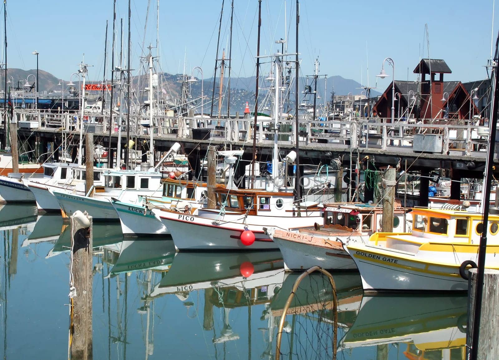 SAN FRANCISCO, CA - JUNE 13,  2008: Quaint and colorful fishing boats at popular tourist destination Fisherman's Wharf in San Francisco.
