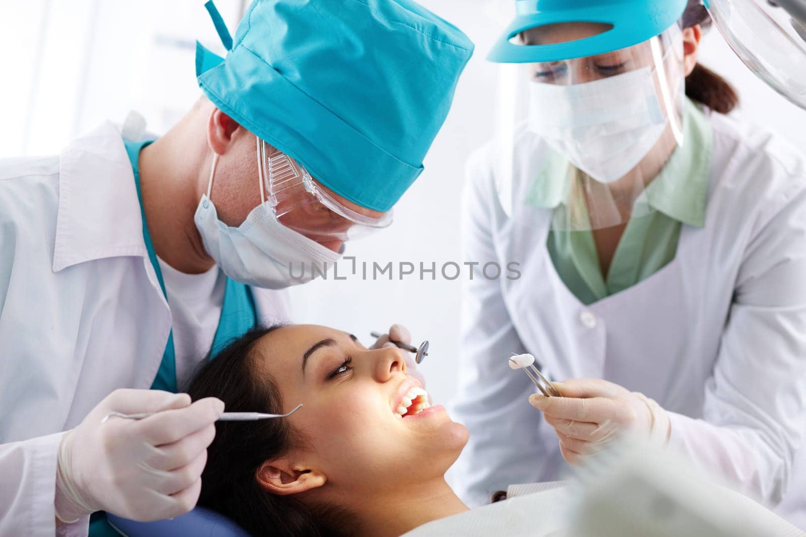 Pretty patient having oral treatment in dental clinic
