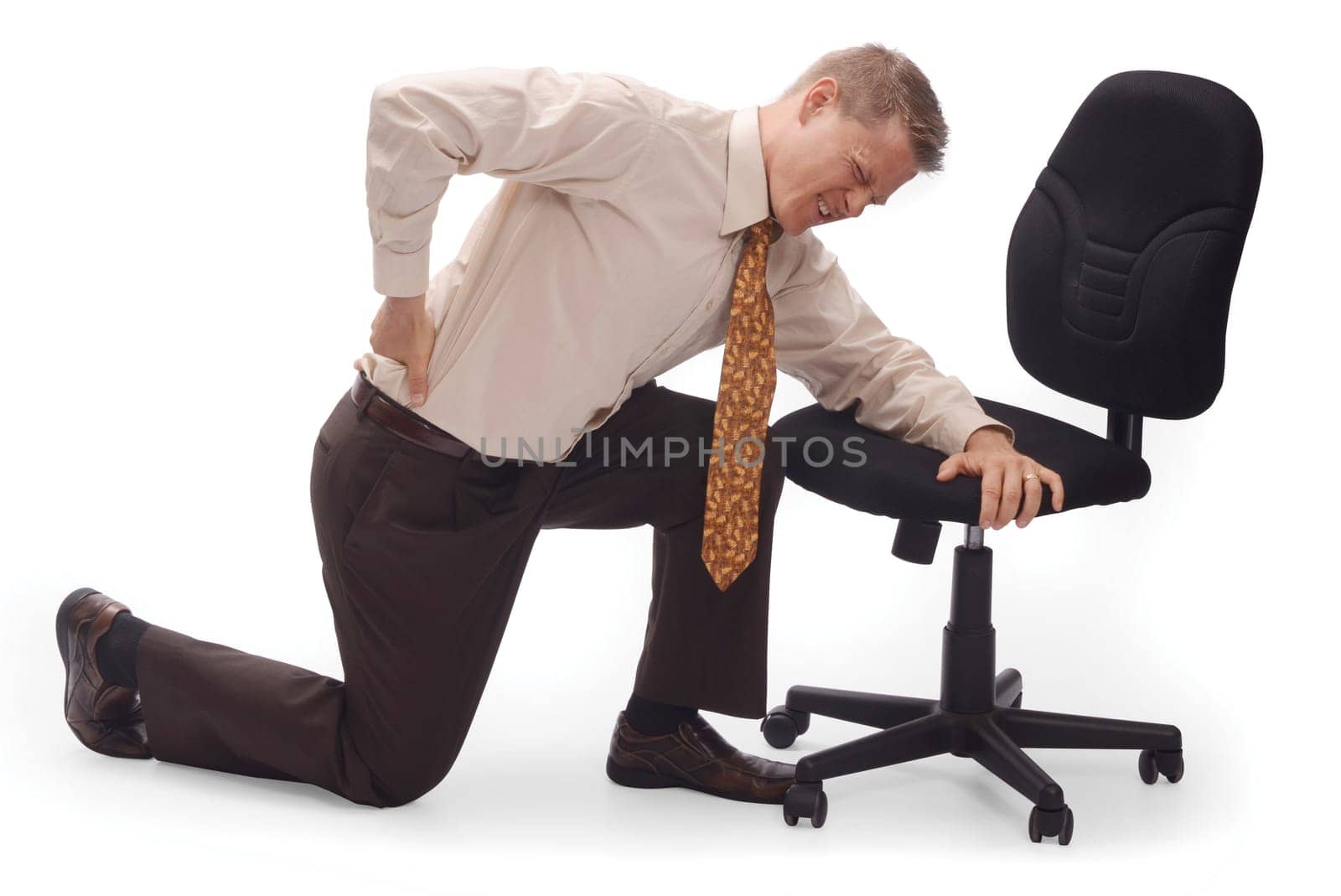 Man kneeling on the floor with back pain on a white background