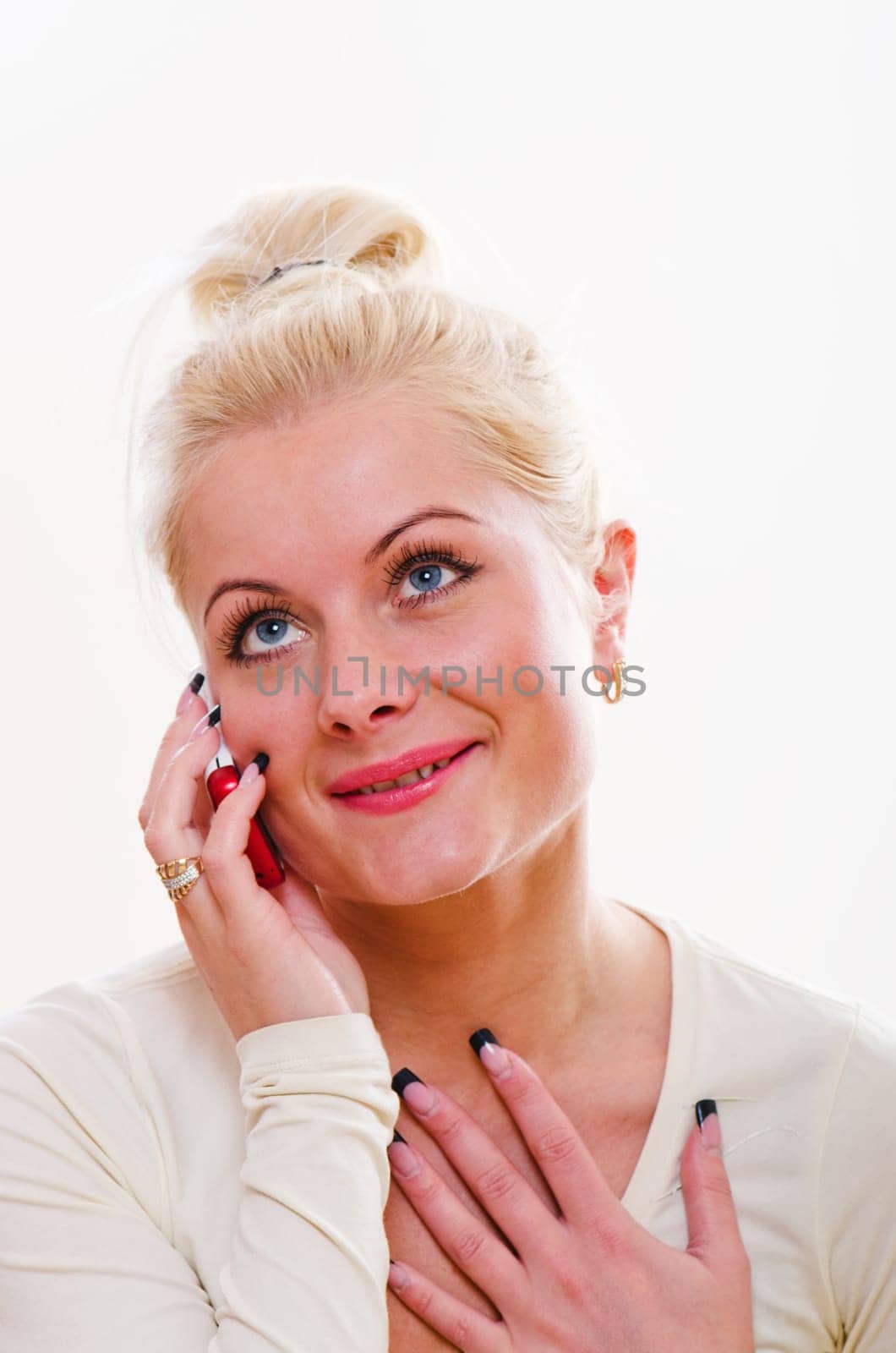 The young woman talks by a mobile phone
