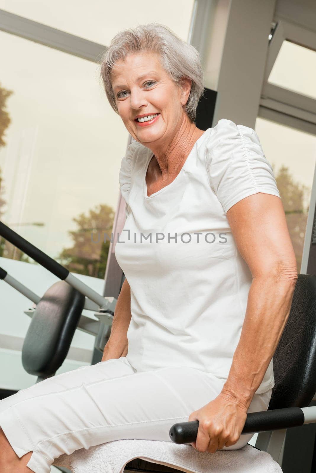 Smiling senior woman in a gym