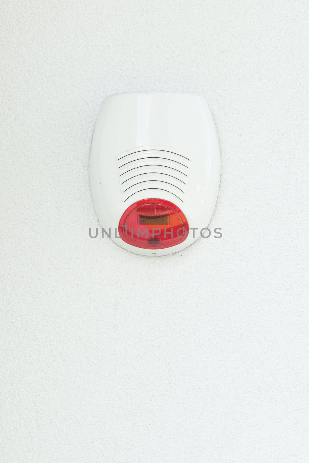 Alarm system on a white house wall