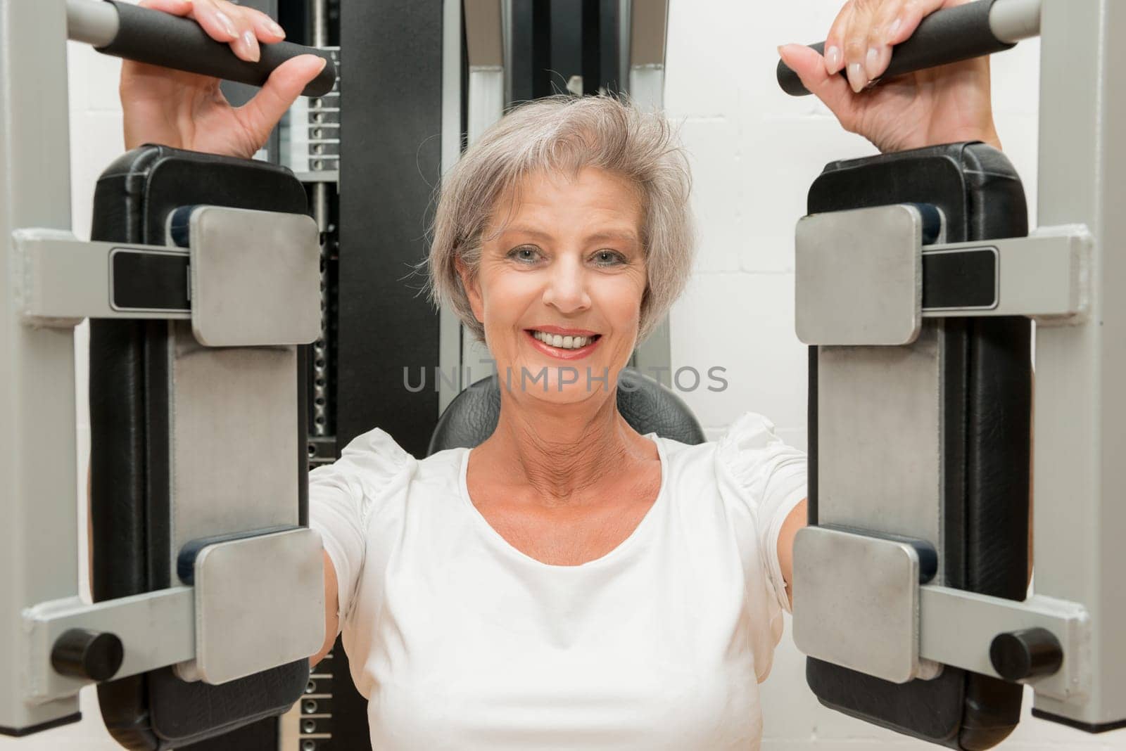 Smiling senior woman in a gym