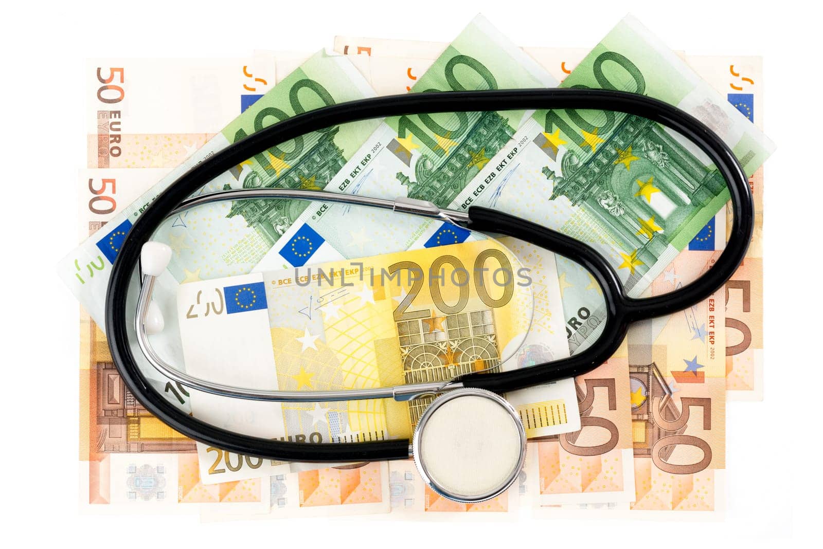 Stethoscope with banknotes against white background