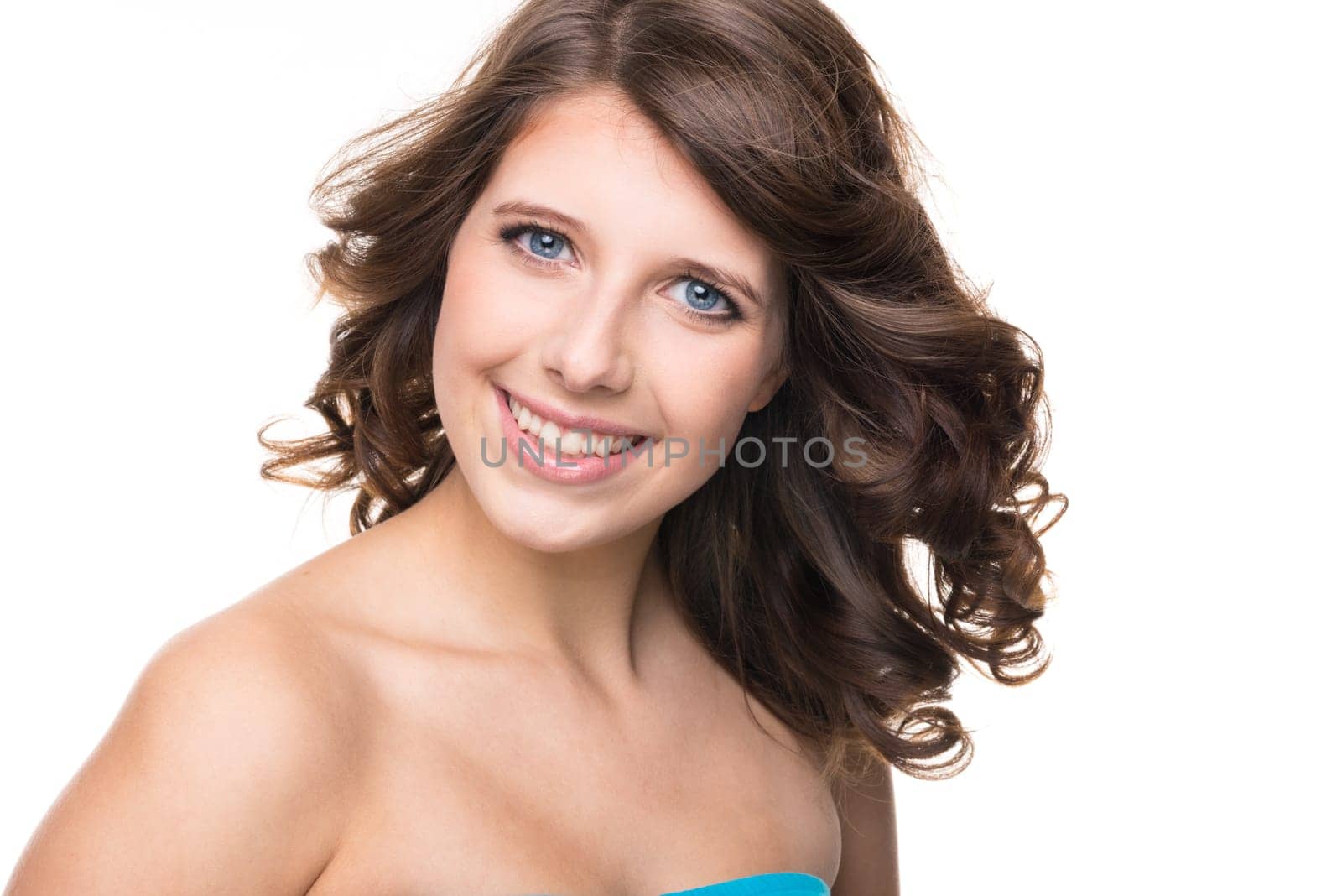Young and smiling girl against white background