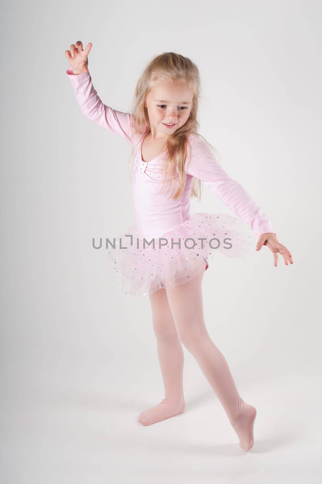 Studio shot of ballet dancer girl in pink