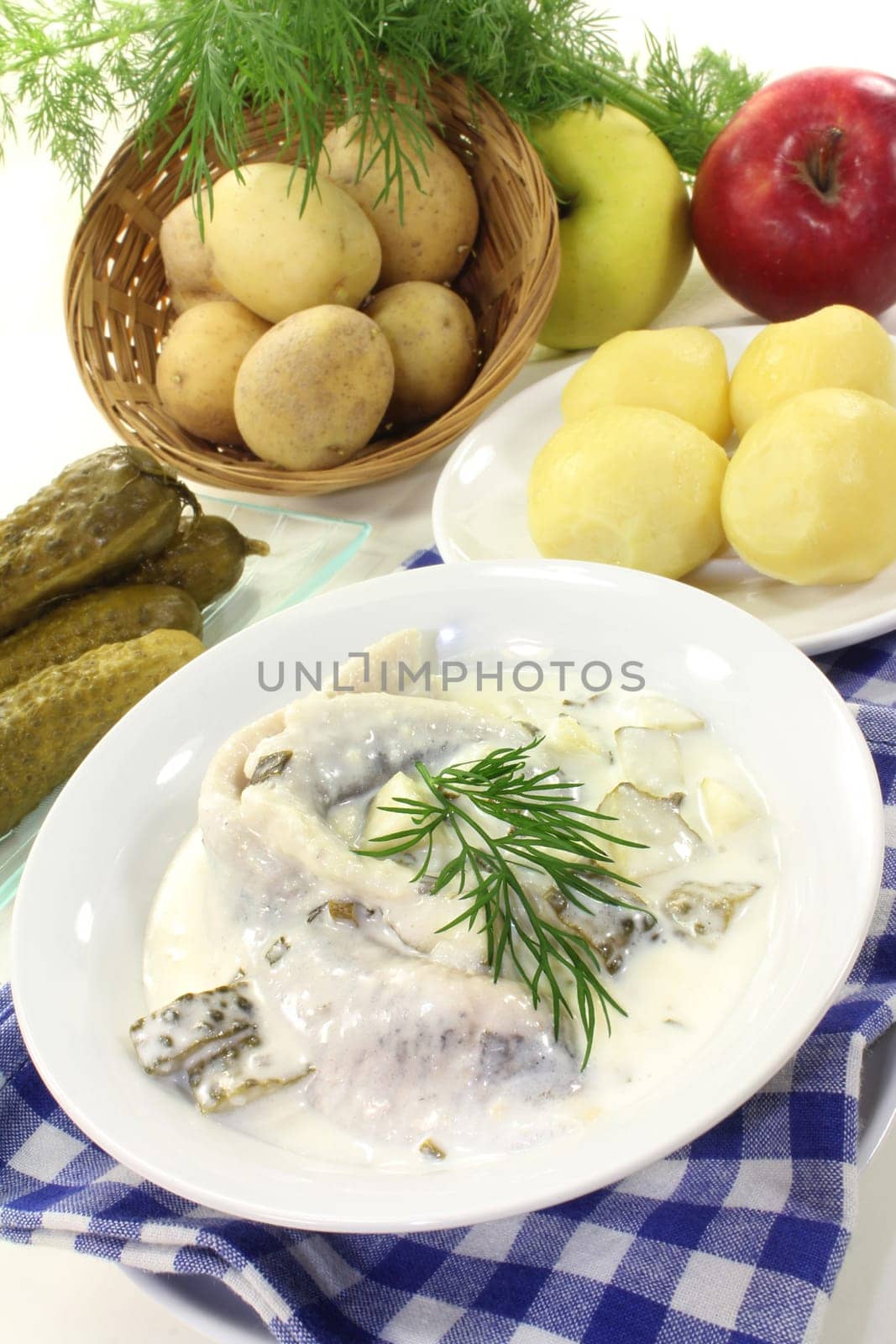 Cream herring with cucumber and jacket potatoes