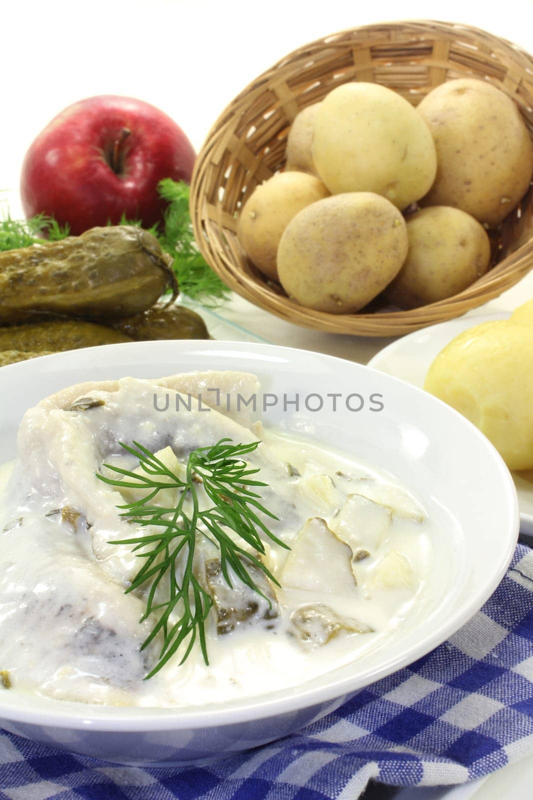 Cream herring with cucumber and jacket potatoes