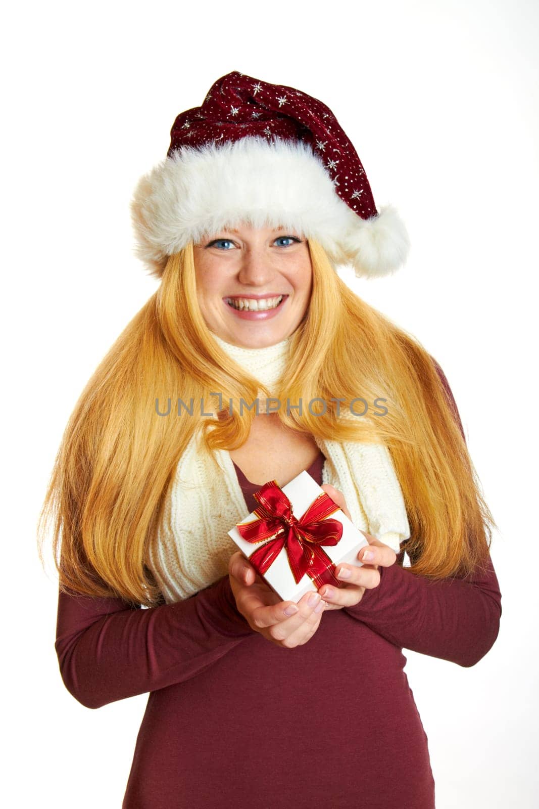 beautiful blonde woman holding a christmas gift is smiling
