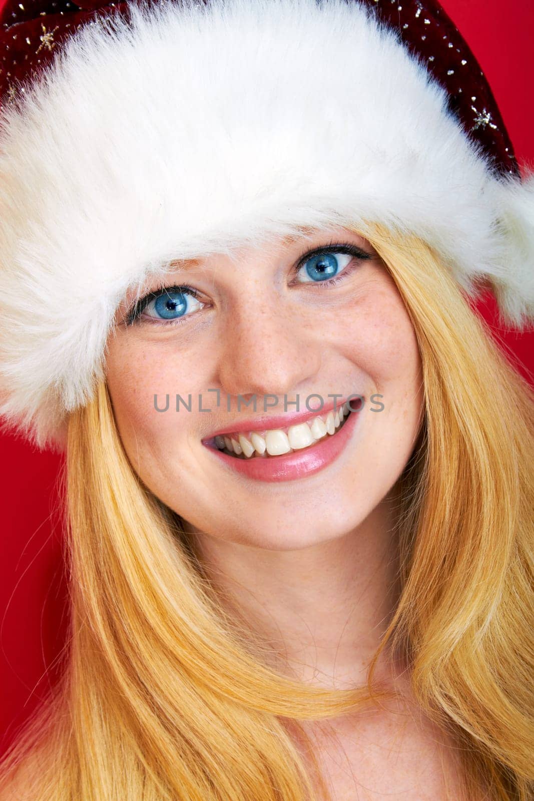 beautiful blonde woman with christmas gift is smiling