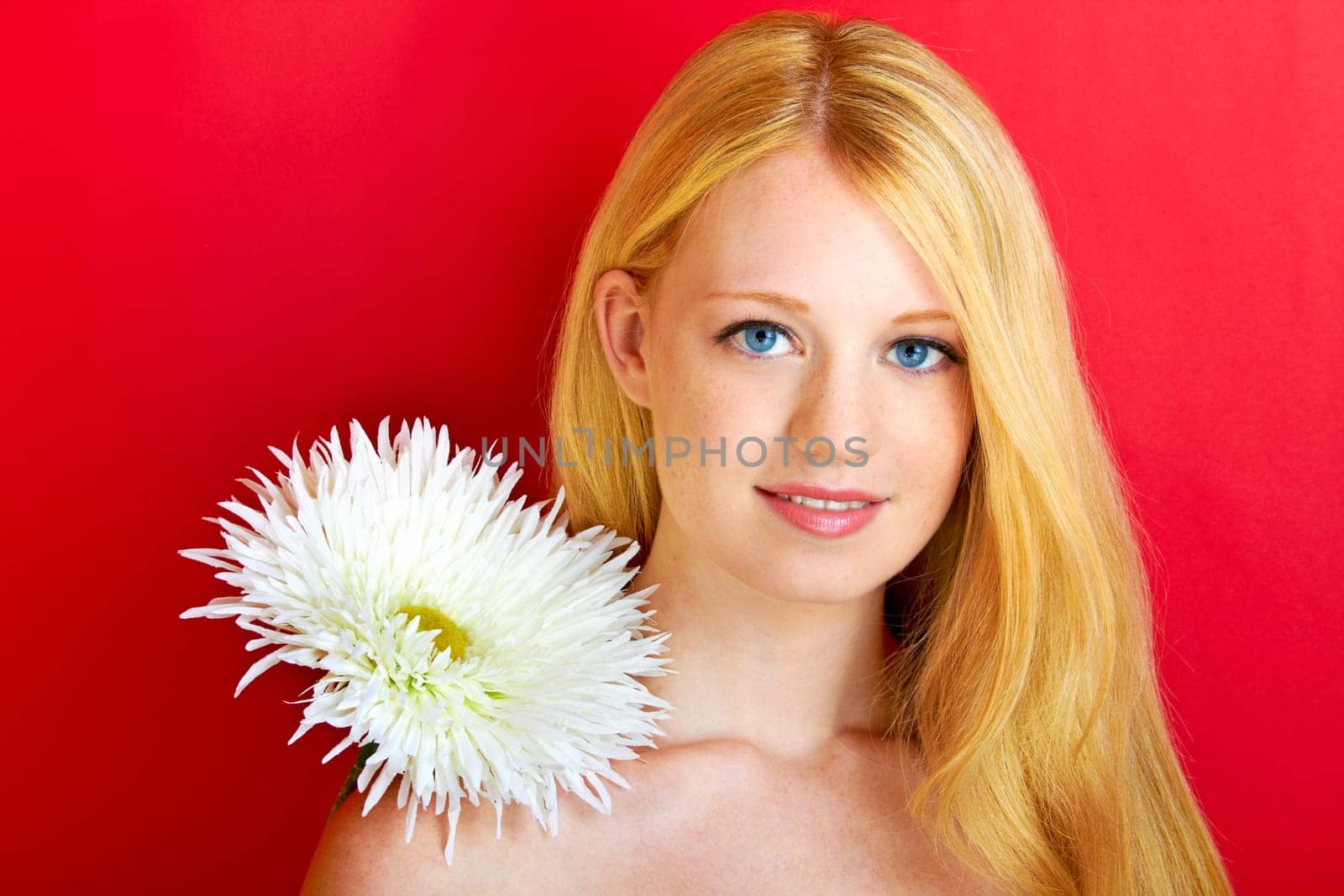 portrait of a young beautiful blonde girl with flower