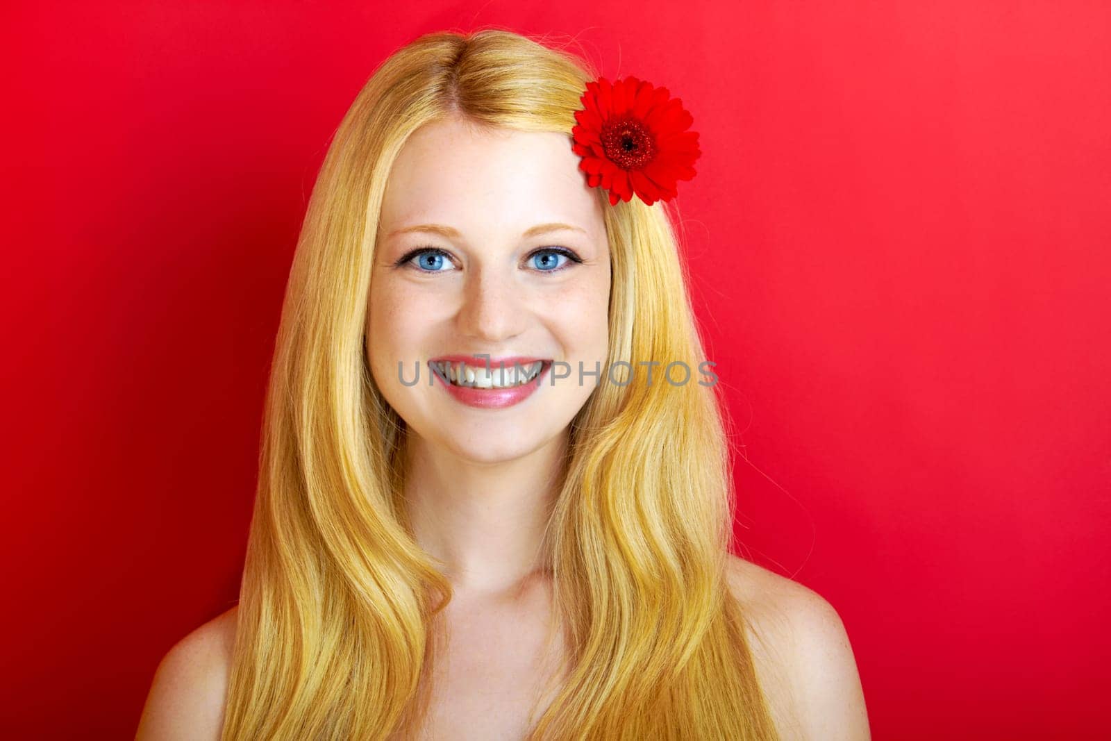 portrait of a young beautiful blonde girl with white flower