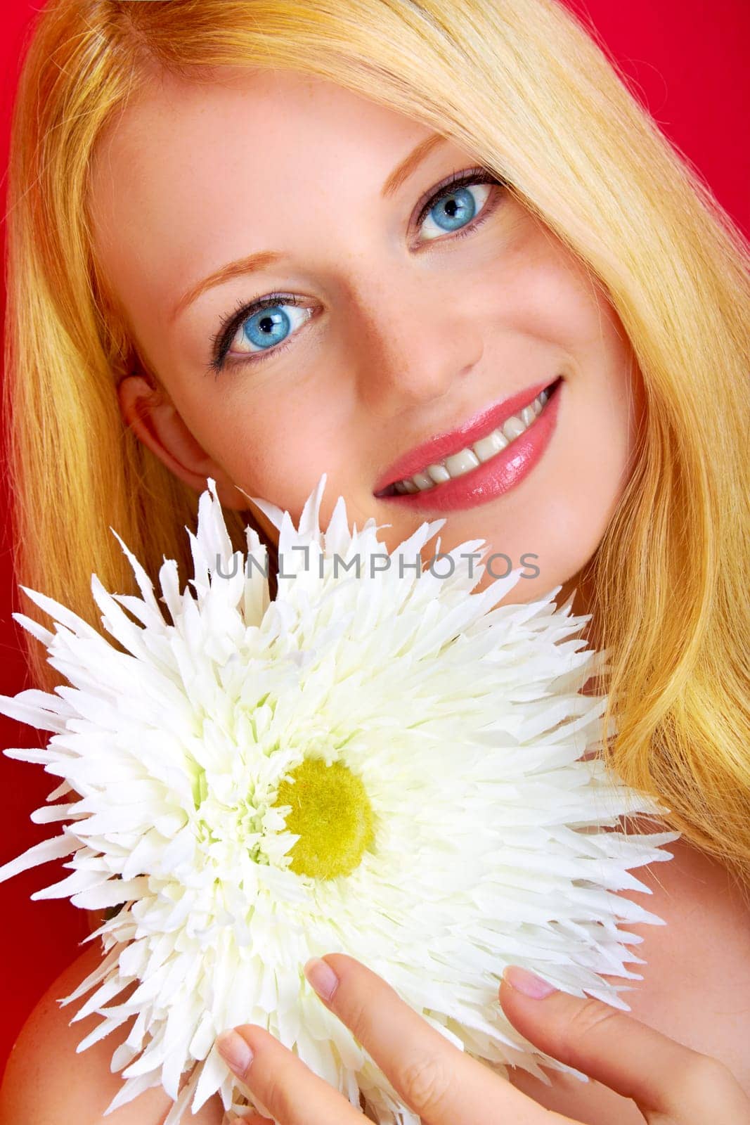 portrait of a young beautiful blonde girl with flower