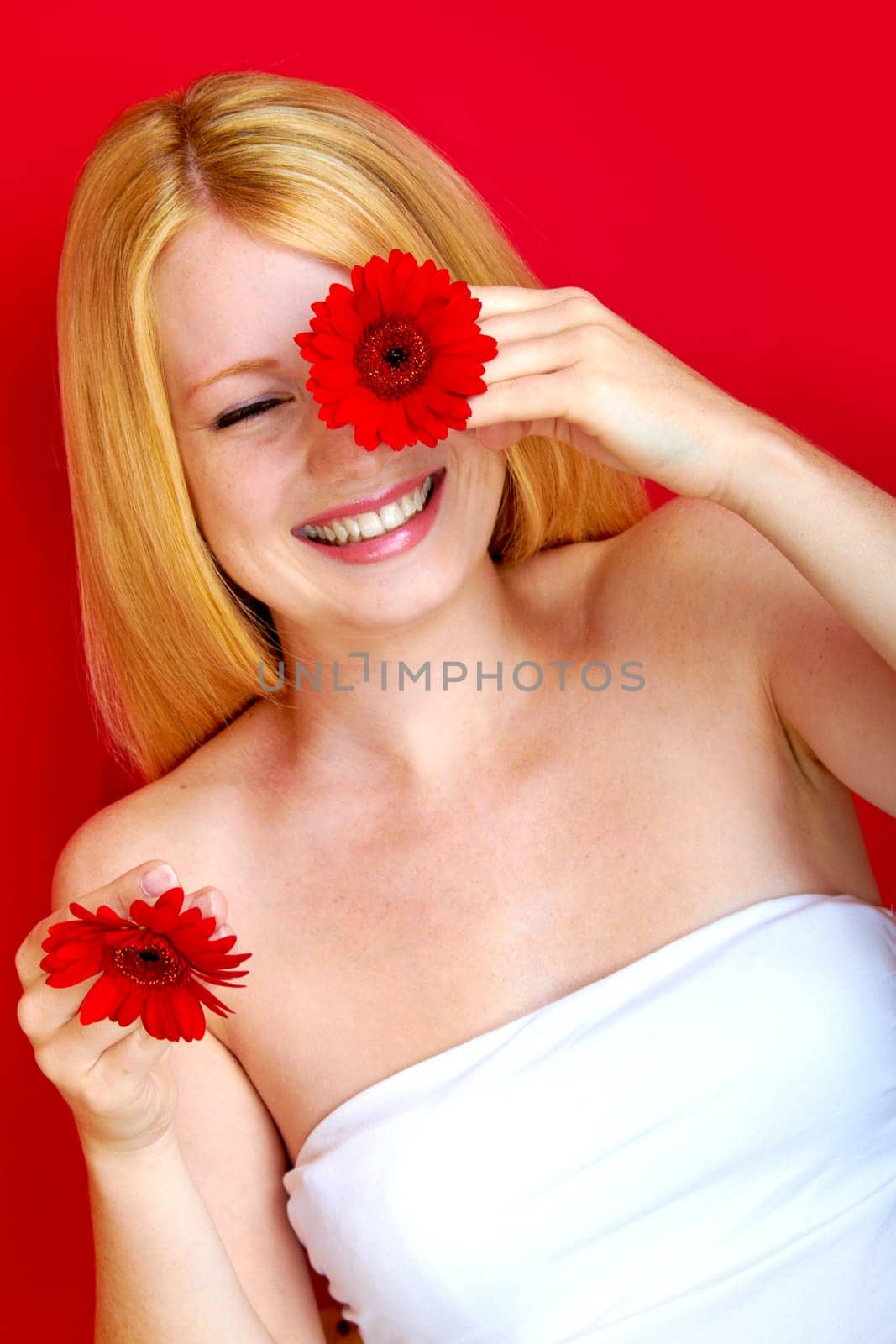 portrait of a young beautiful blonde girl with flower