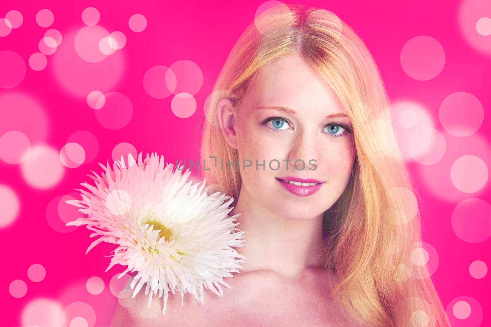 portrait of a young beautiful blonde girl with white flower