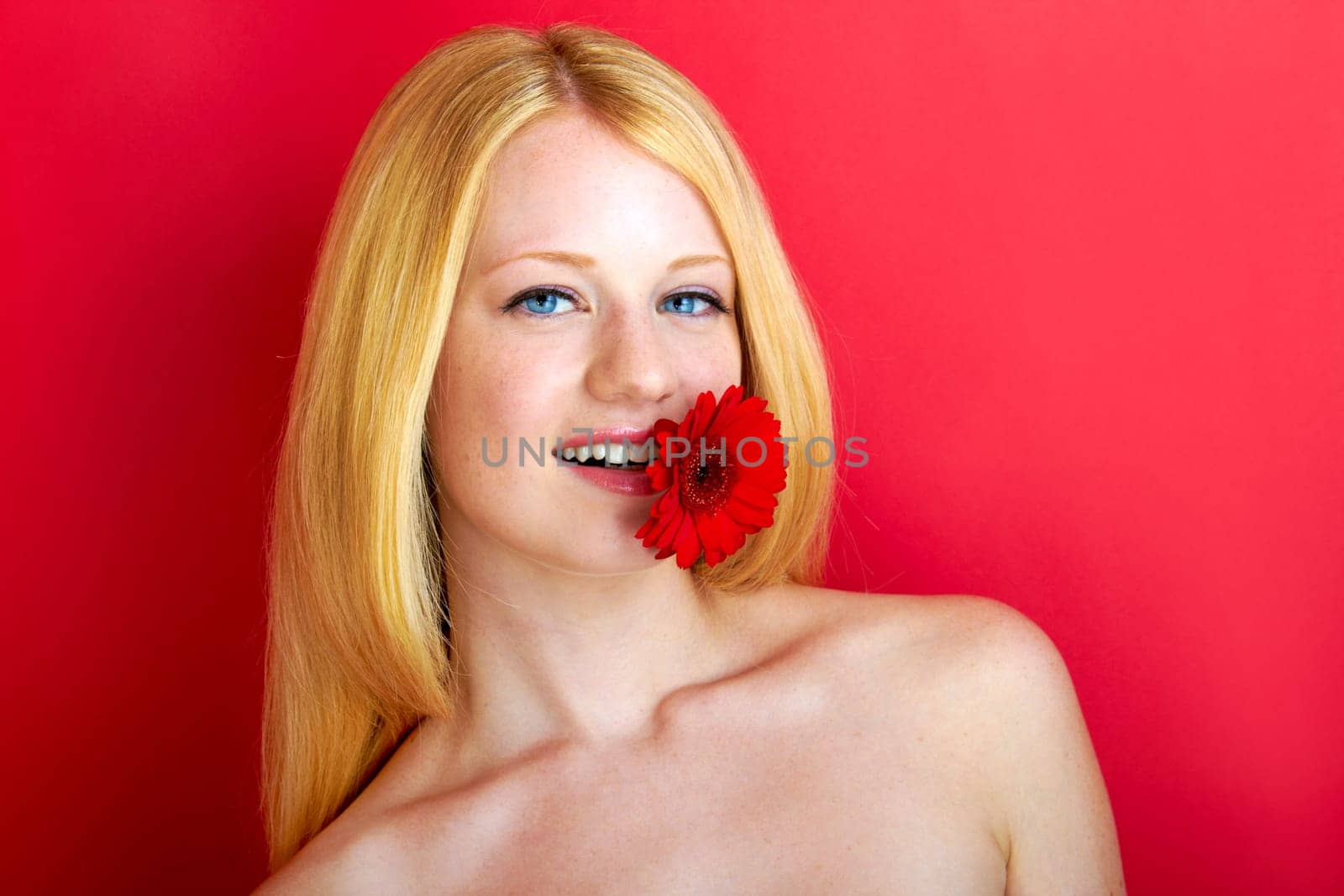 portrait of a young beautiful blonde girl with flower