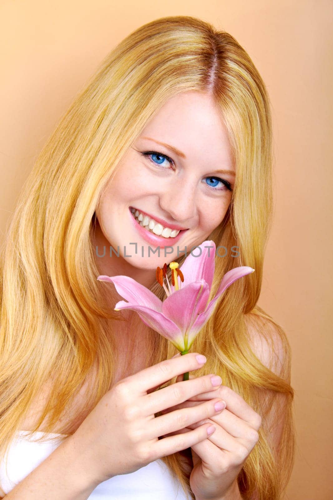 portrait of a young beautiful blonde girl with white flower