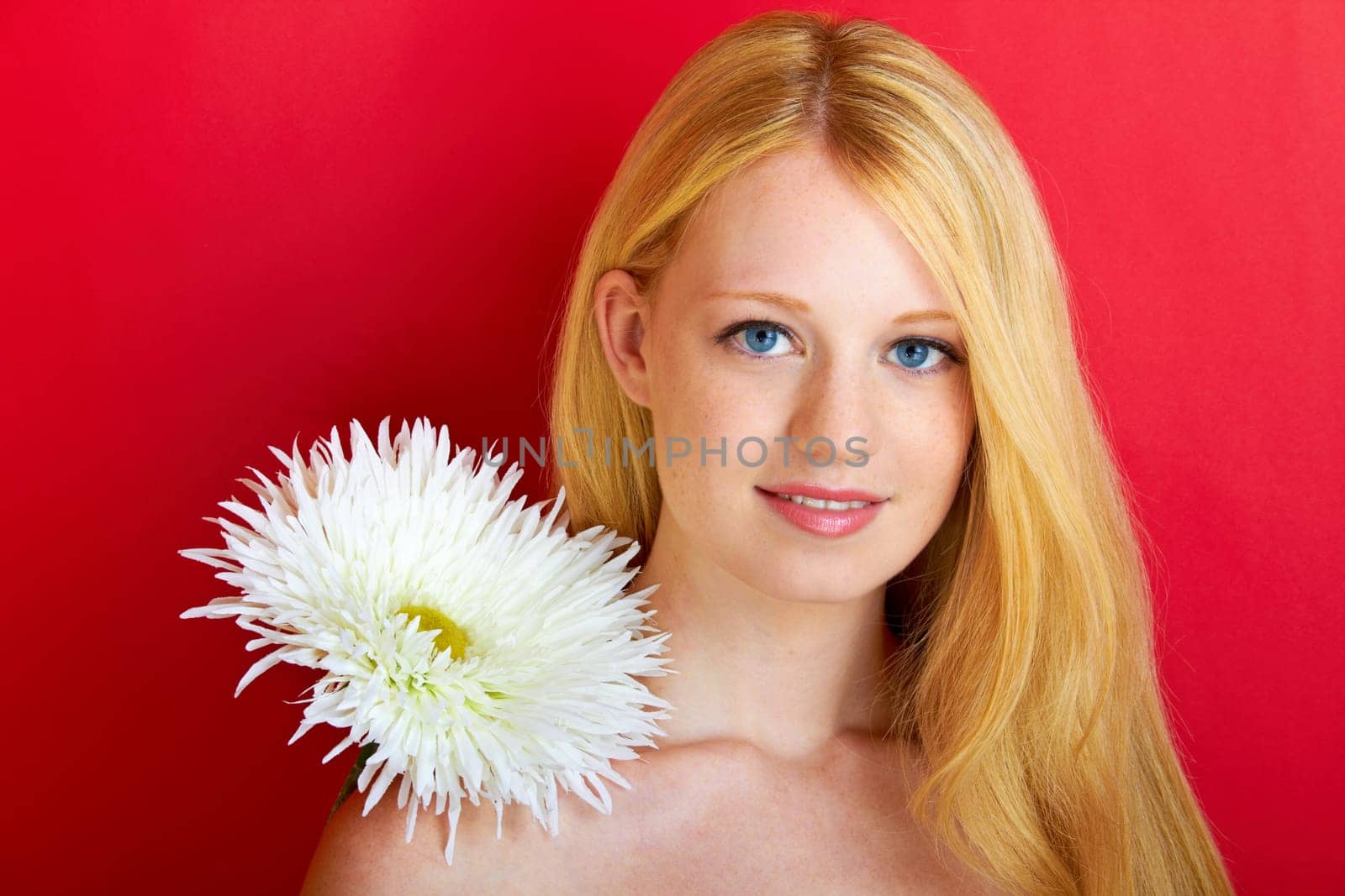 portrait of a young beautiful blonde girl with flower