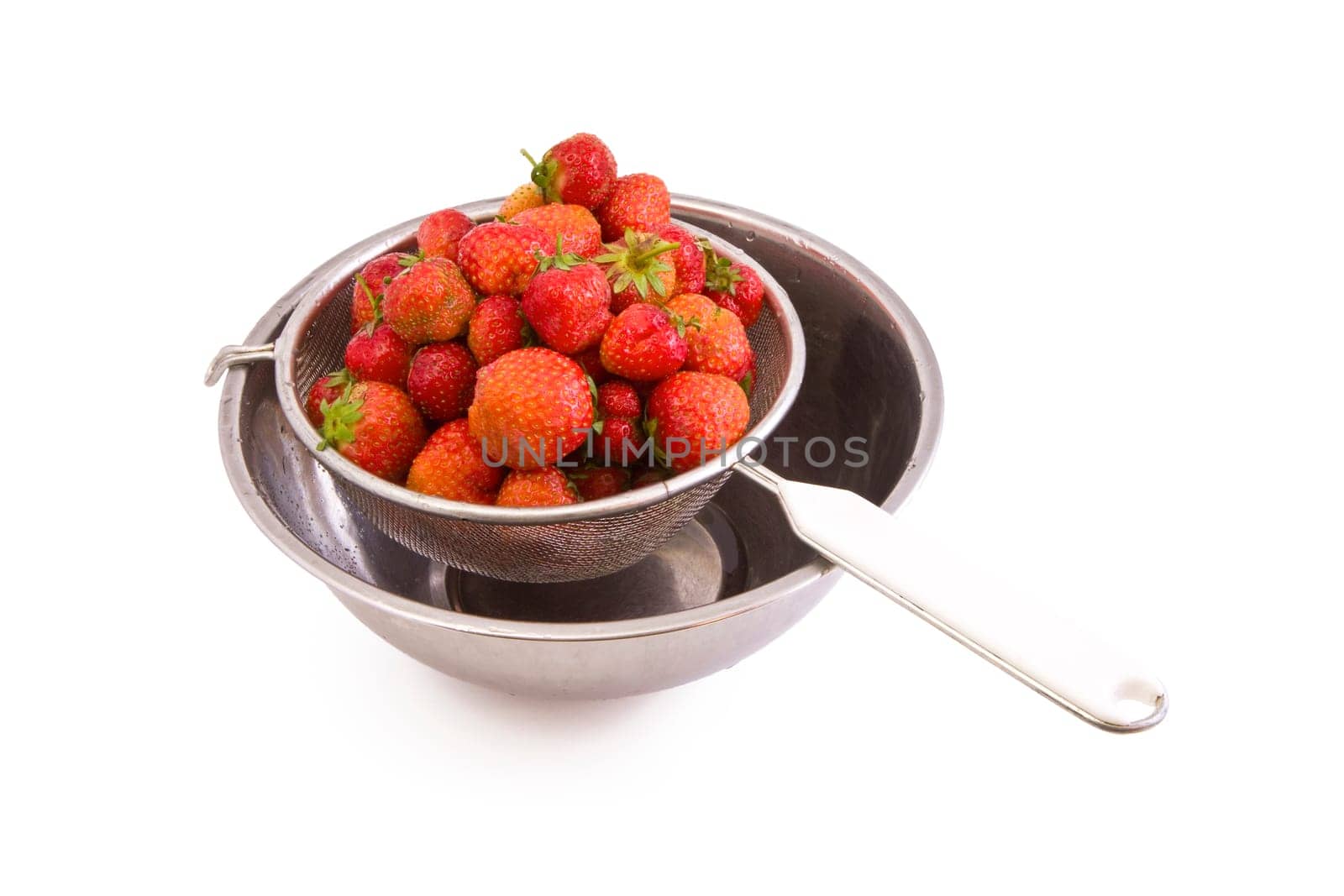 Fresh tasty strawberries in a colander isolated on white