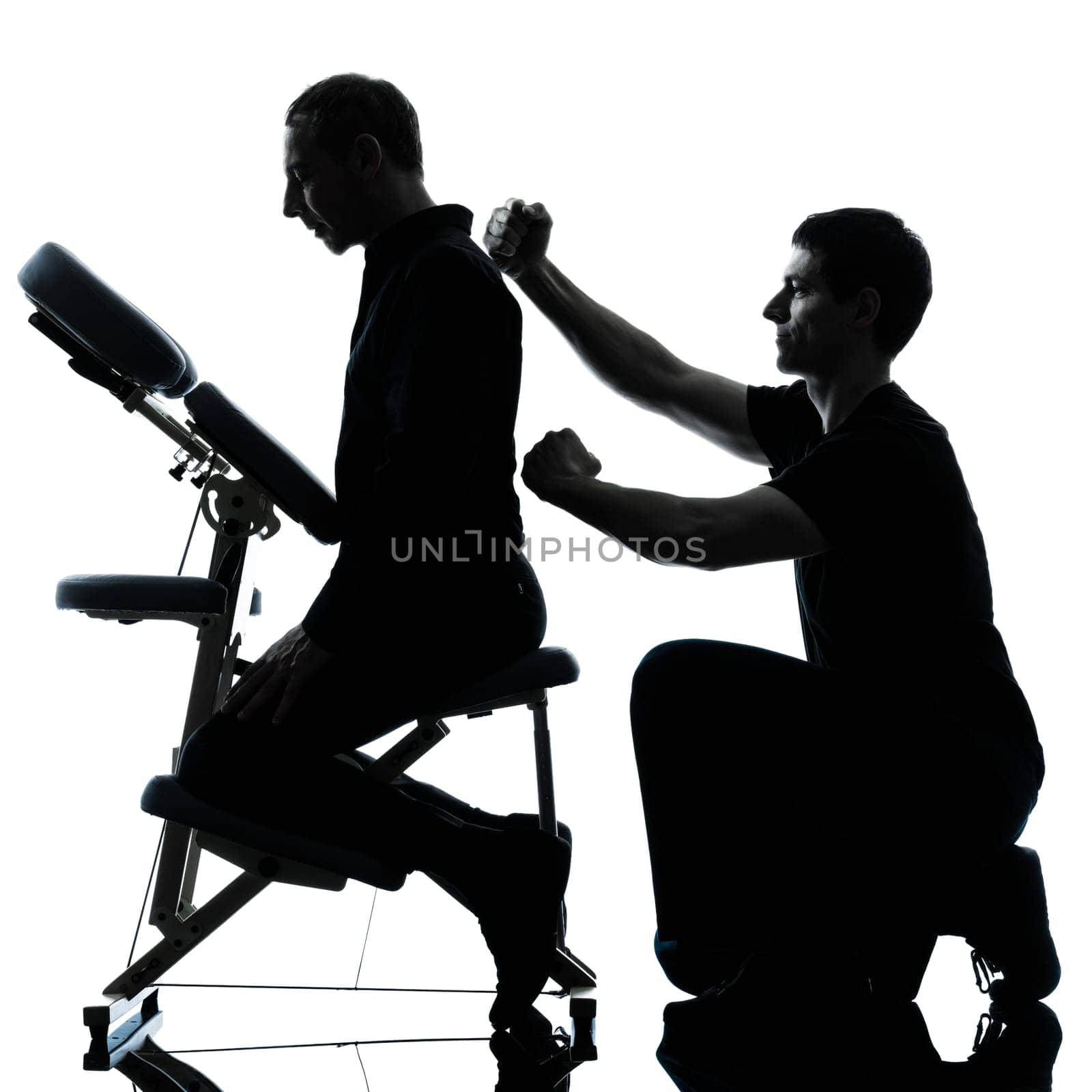 two men performing chair back massage in silhouette studio on white background