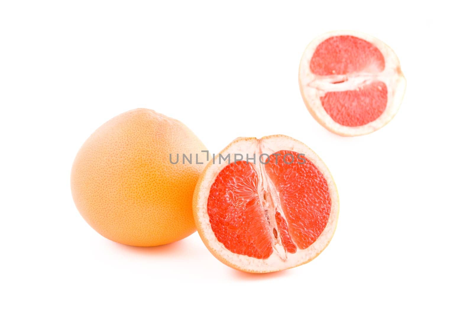 Fresh juicy red grapefruits isolated on white background