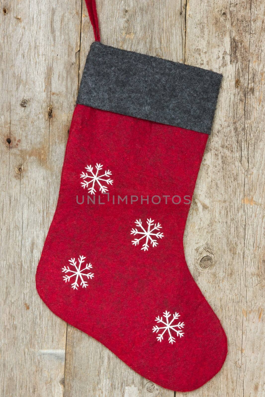 Red christmas sock hung on the old wooden wall