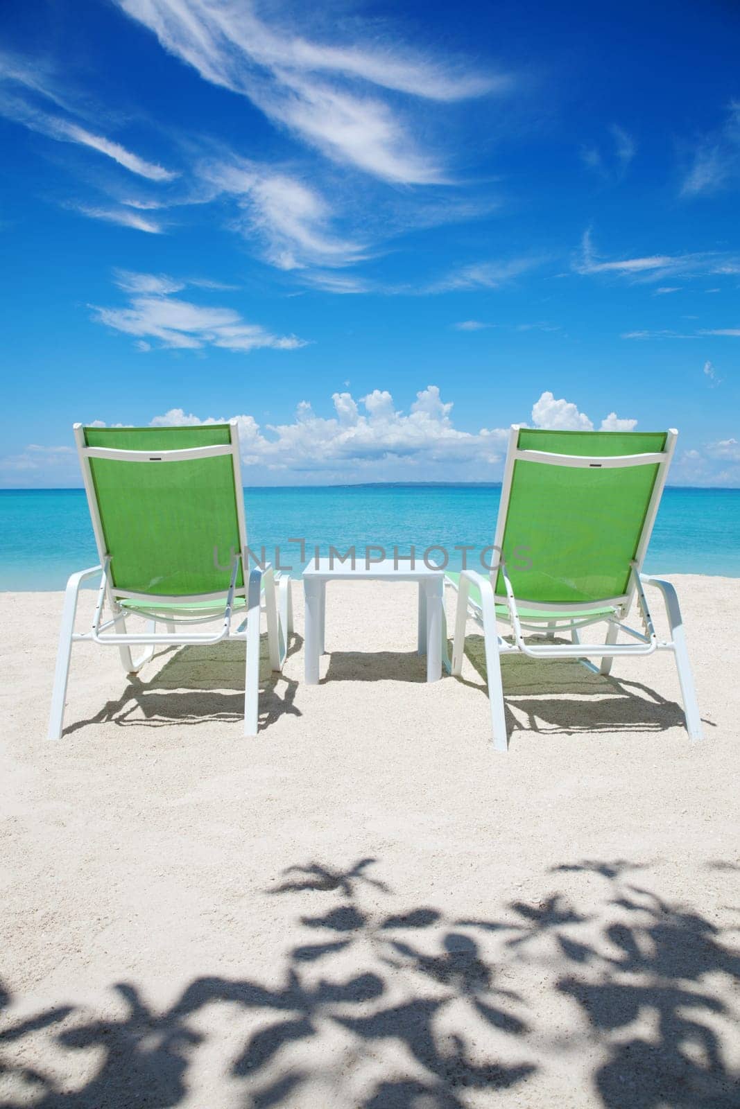 Two deckchairs on a beautiful beach