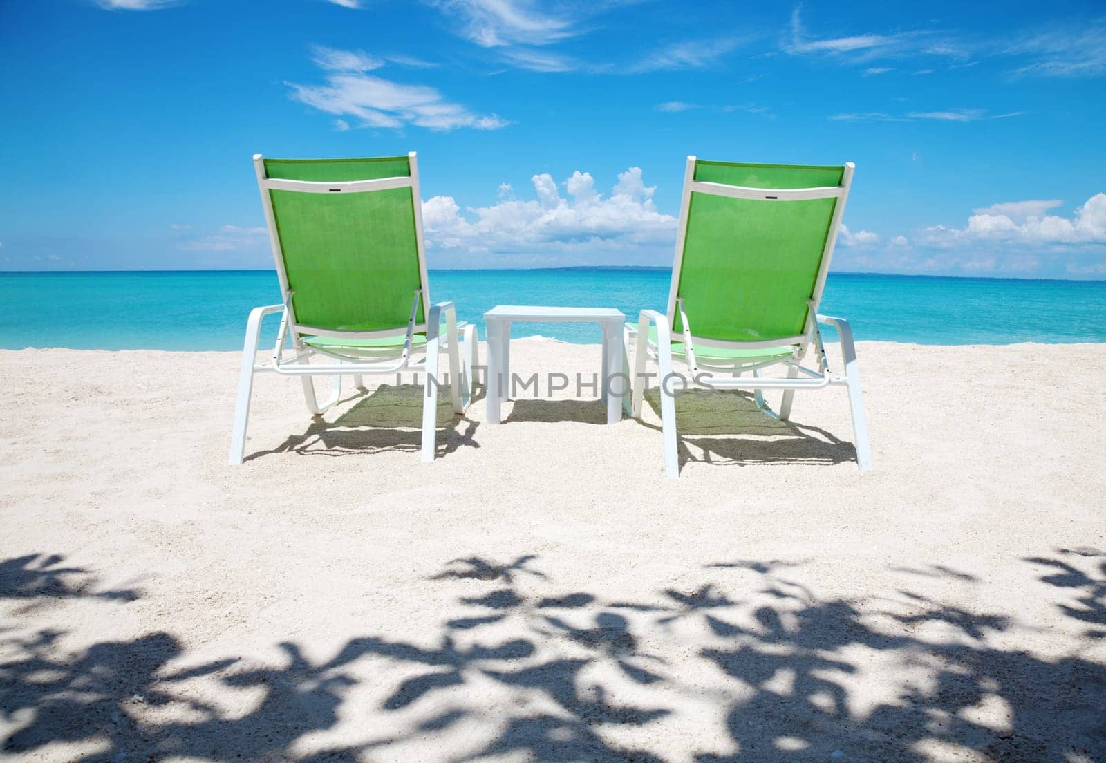 Two deckchairs on a beautiful beach
