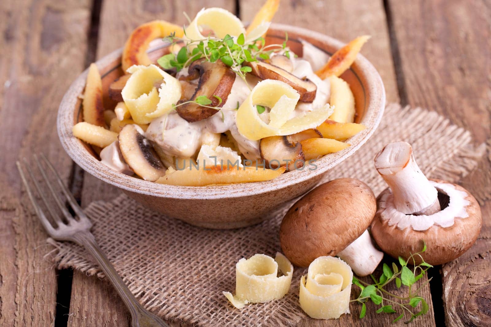 golden brown potato noodles with fresh champions