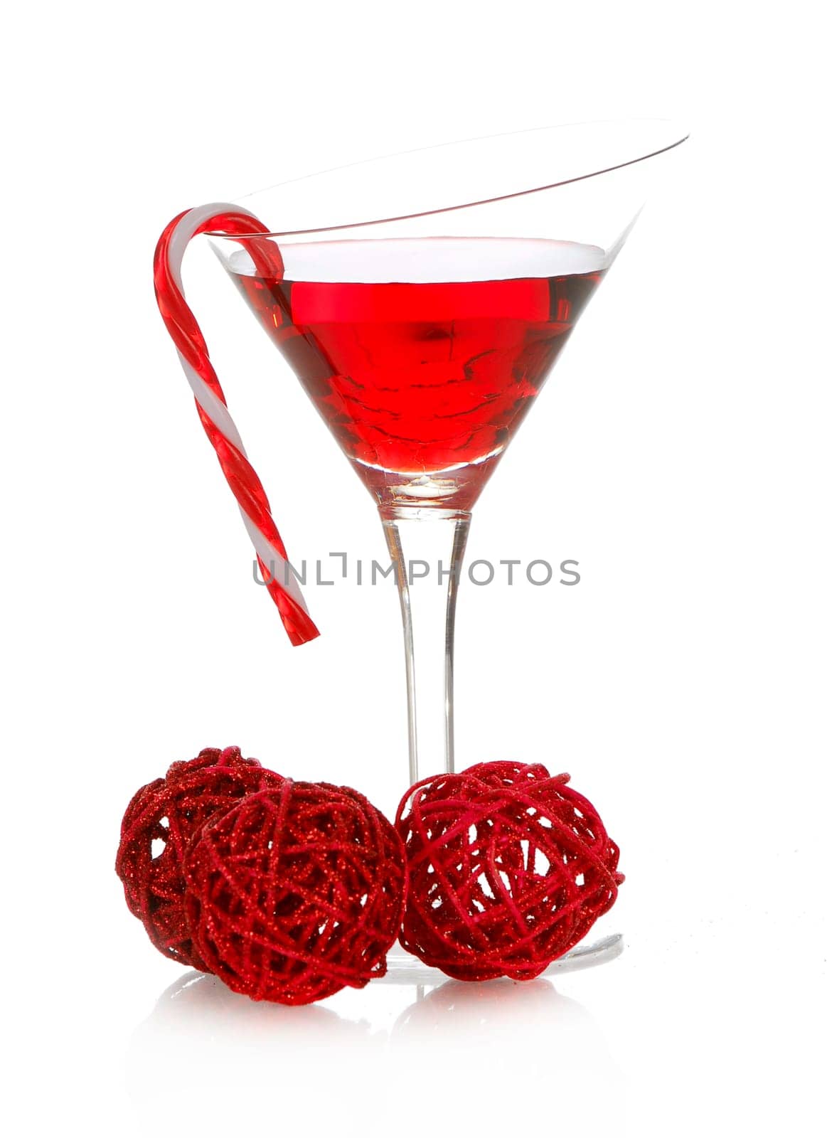 christmas cheer - colorful cocktail with candy cane on the side isolated on white background