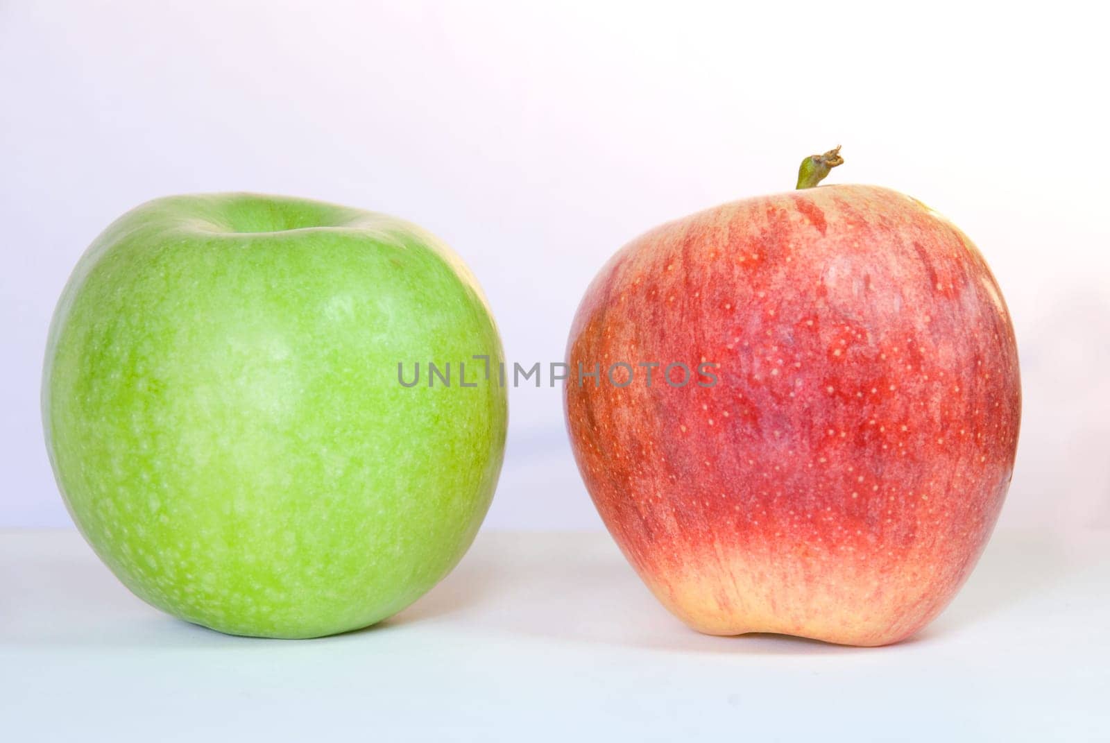 one green and one red apple, on white